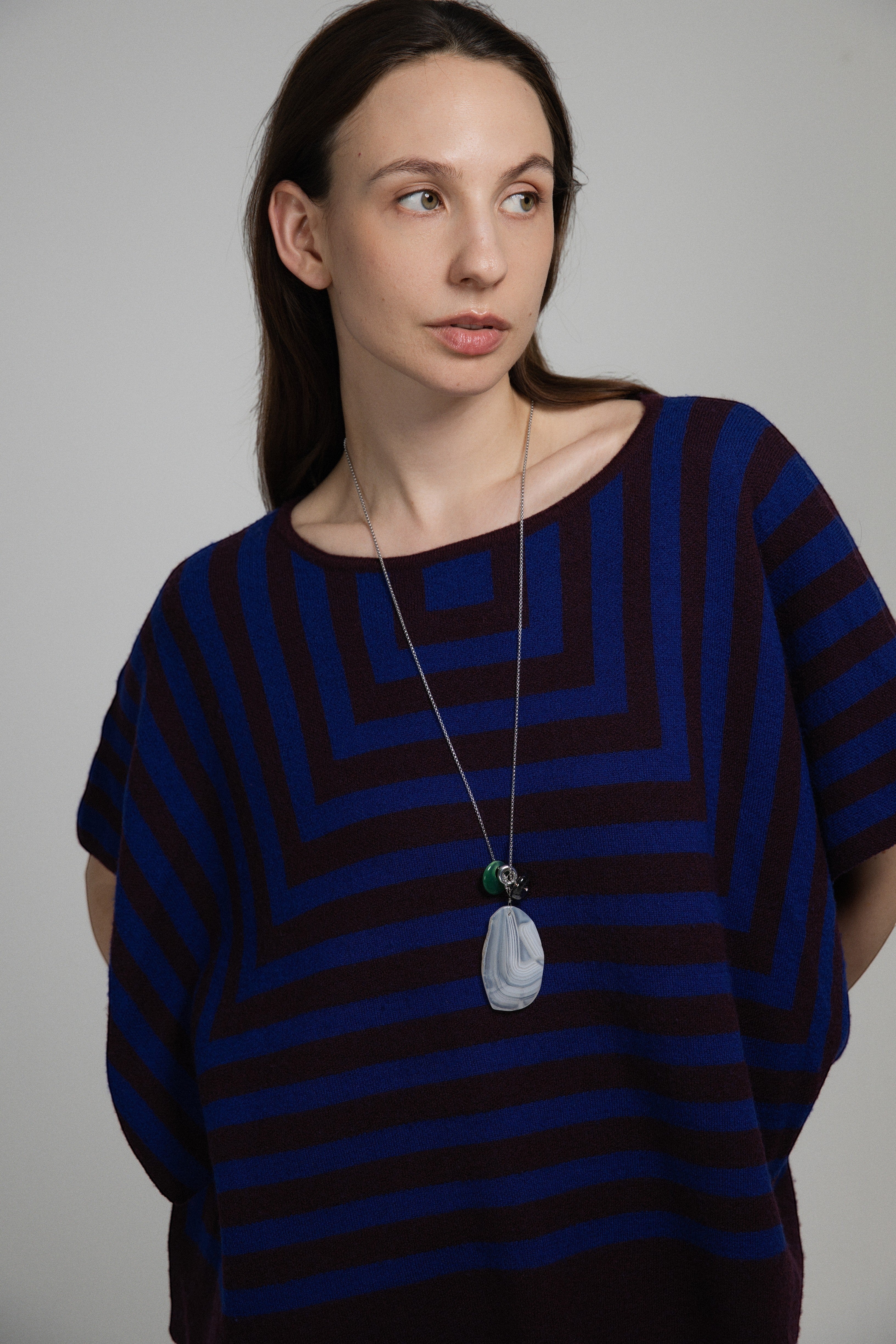 Model wearing an Elsita Jewelry Glacier Night necklace featuring white agate, green agate, and smoky quartz on a chain.