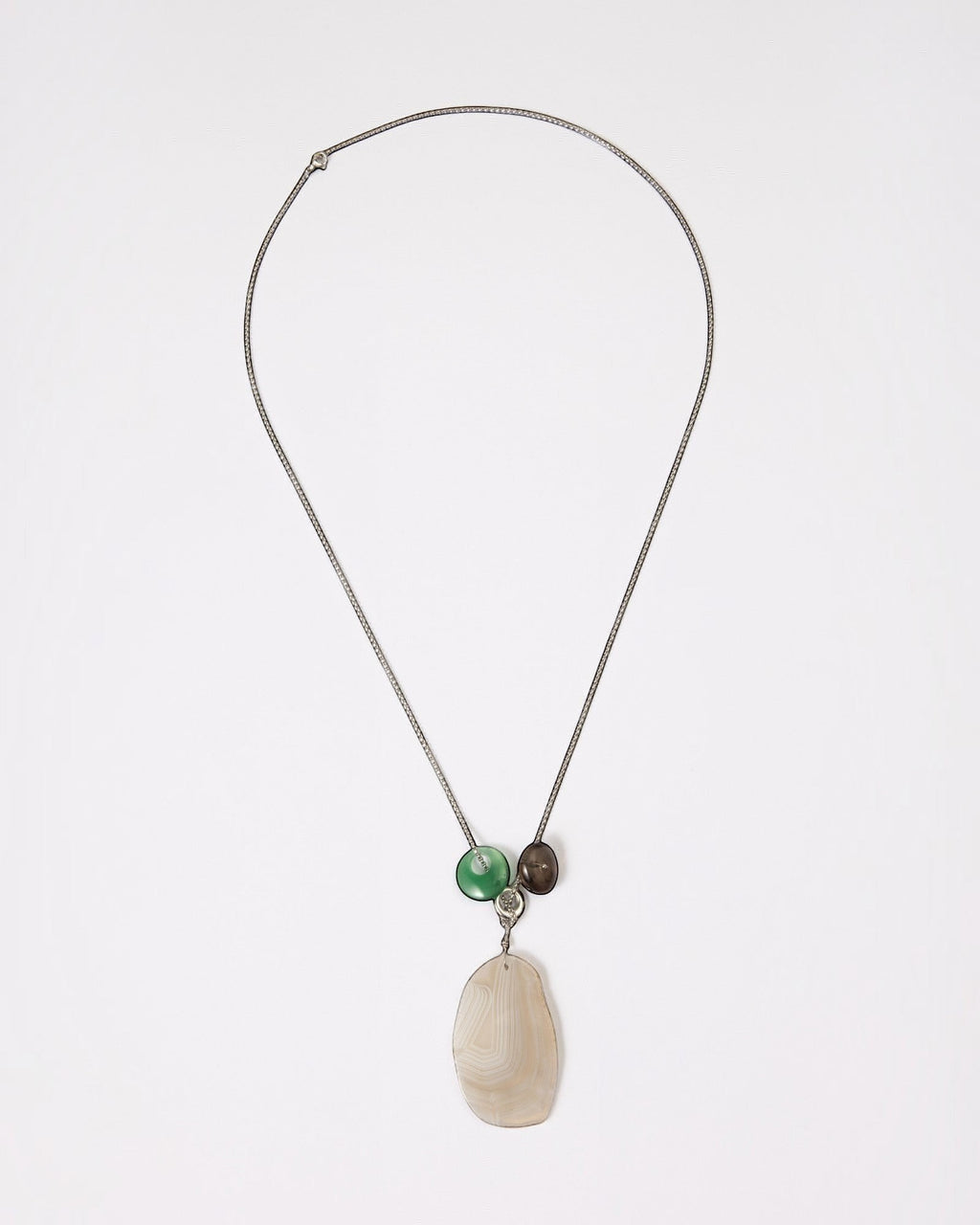 Elsita Jewelry Glacier Night necklace featuring a white agate slice, green agate ring, and smoky quartz on a silver chain.