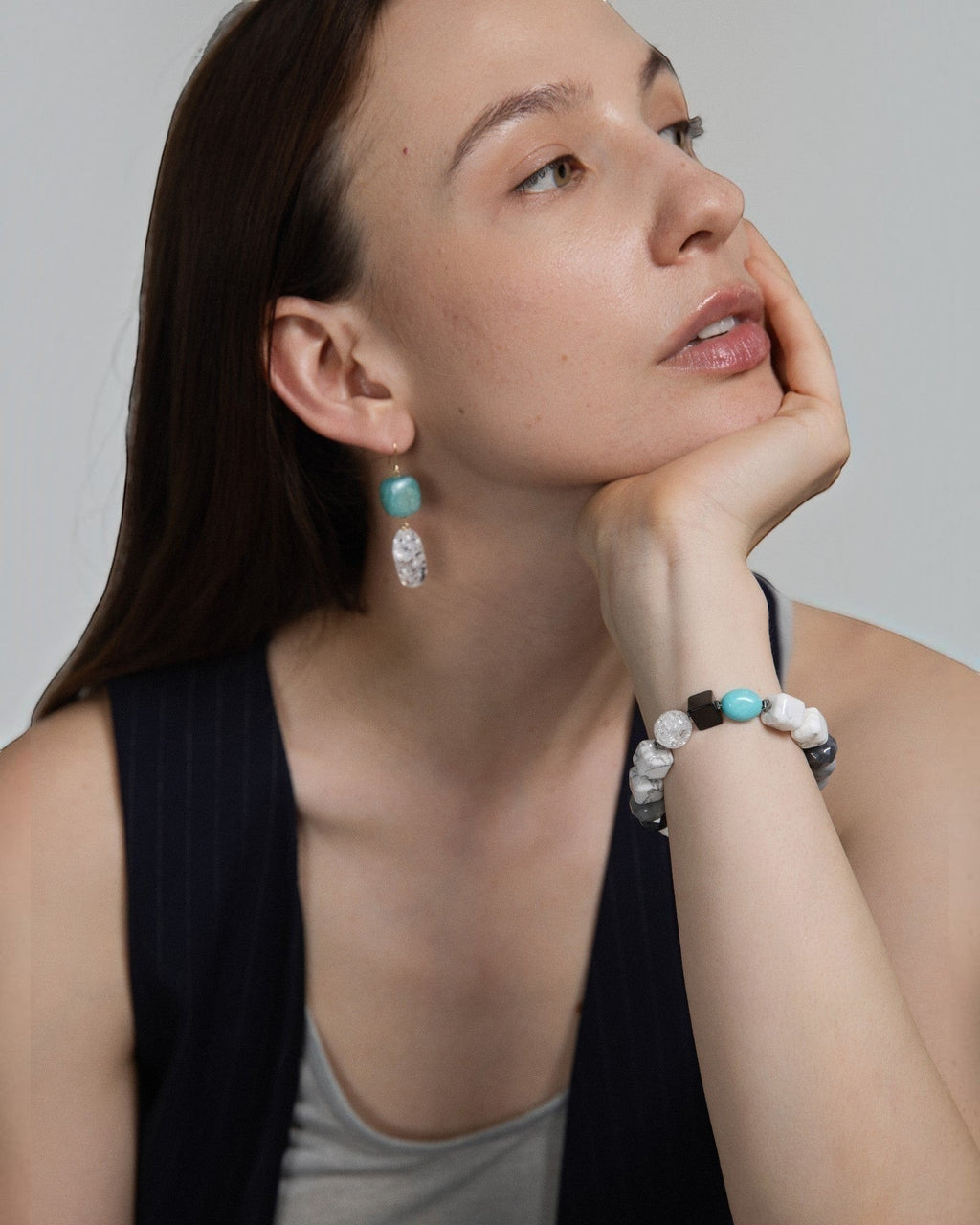 Elsita Jewelry Amazonite and clear quartz drop earrings worn by a woman with a matching stone bead bracelet