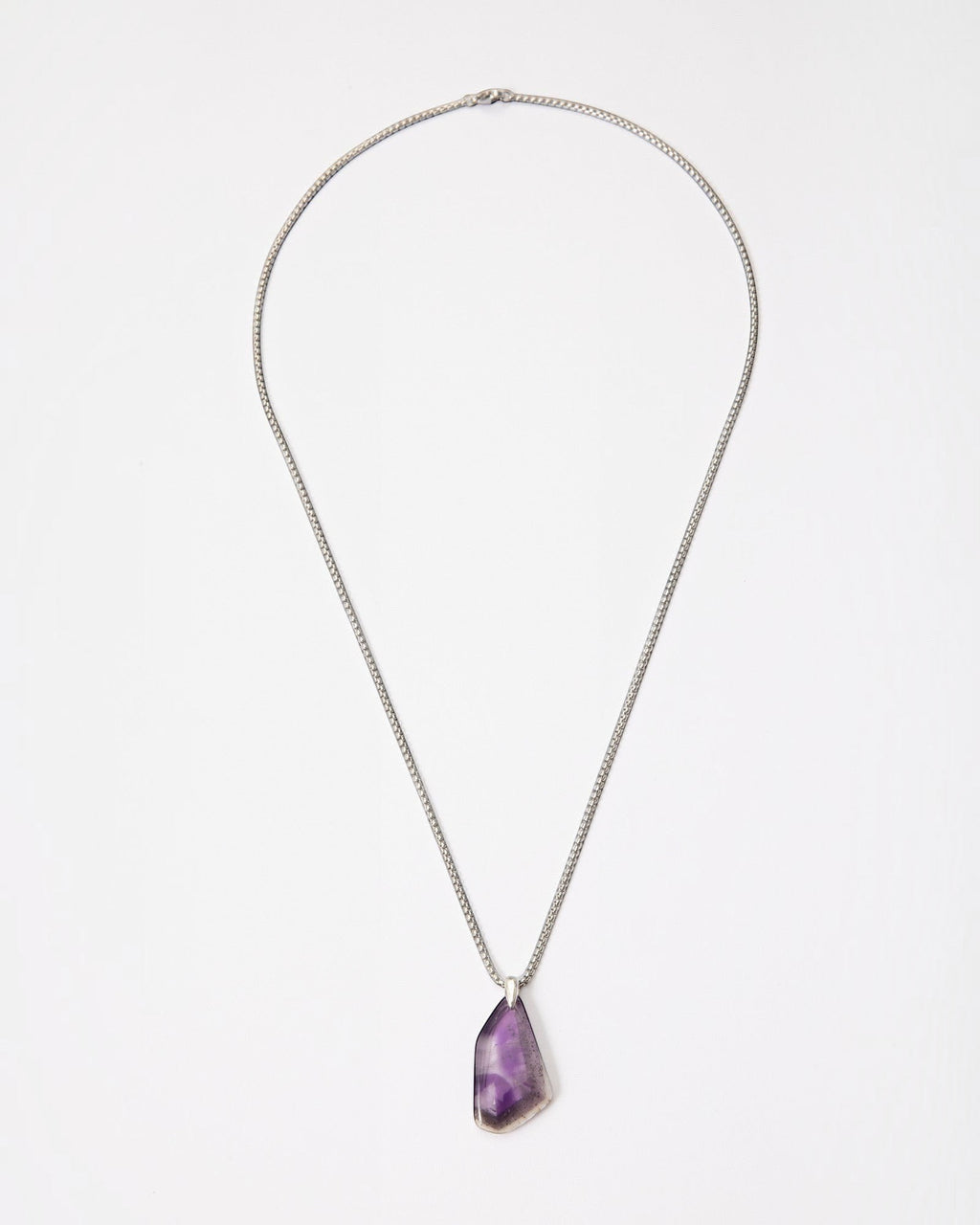 Elsita Jewelry Kaleidoscope III amethyst pendant necklace with a raw purple crystal stone on a sterling silver chain.