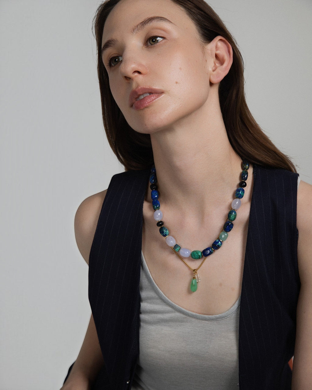 Model wearing Elsita Jewelry Bamboo necklace featuring a green chrysoprase teardrop pendant and clear quartz beads.