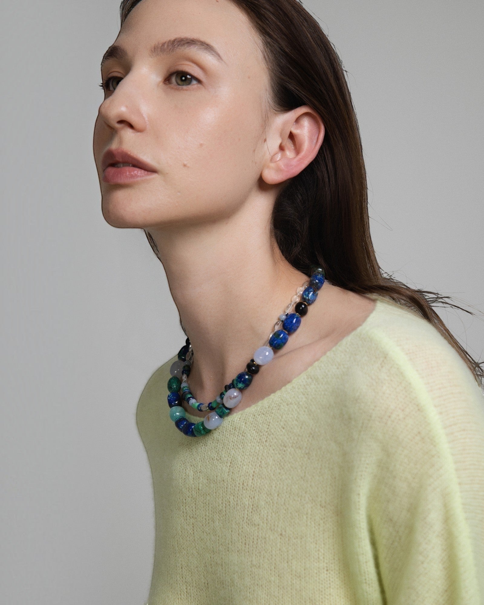 Model wearing Elsita Jewelry Blausee Depth necklace featuring azurite, amazonite, chalcedony, and black tourmaline beads