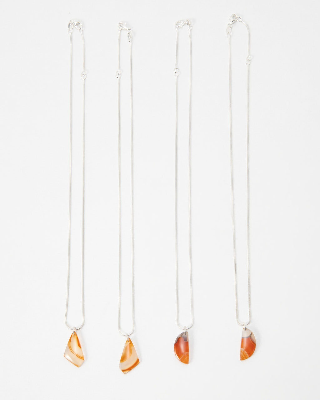 Elsita Jewelry Citrus I necklaces featuring orange agate stone pendants on delicate silver chains