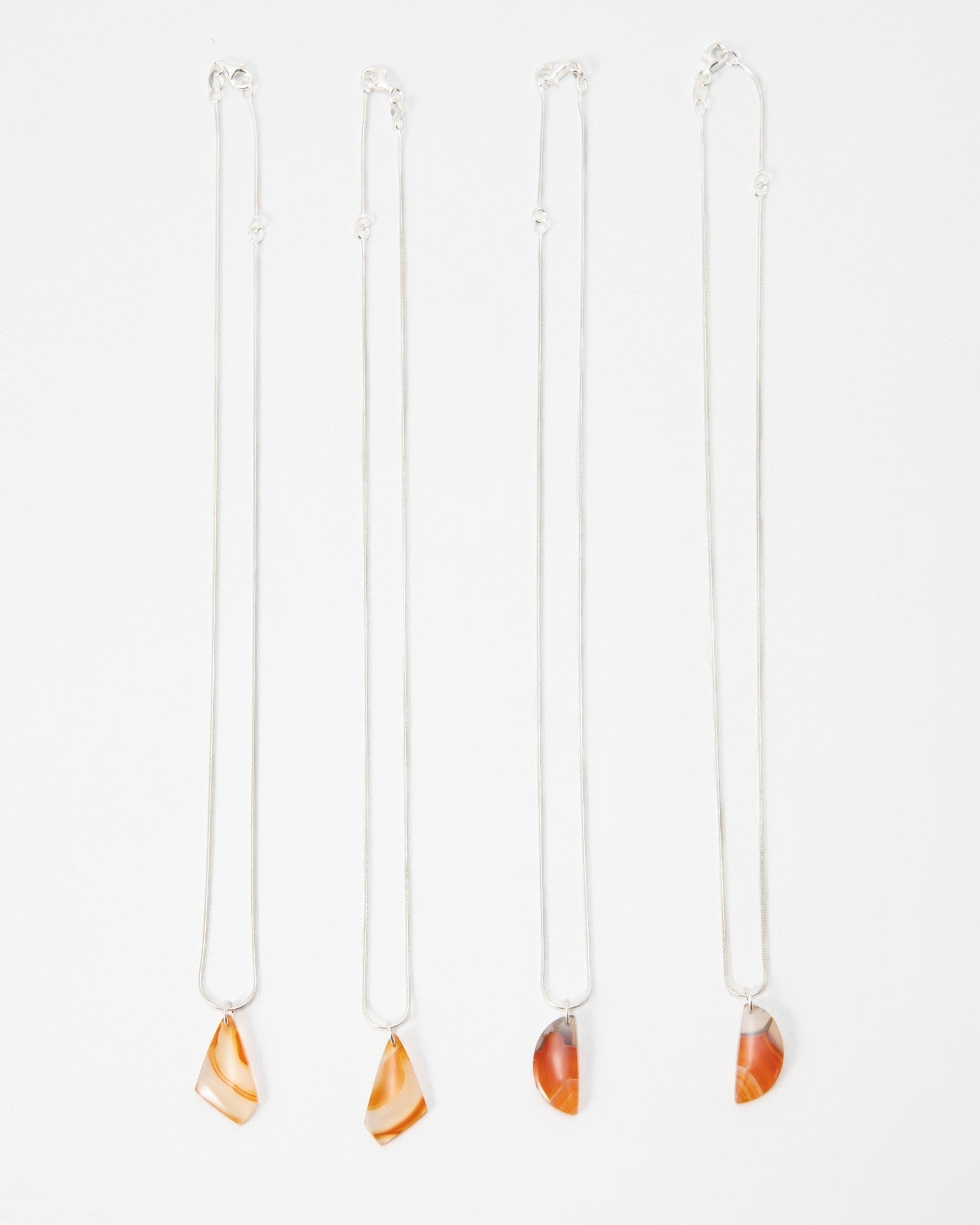 Elsita Jewelry Citrus I necklaces featuring orange agate stone pendants on delicate silver chains
