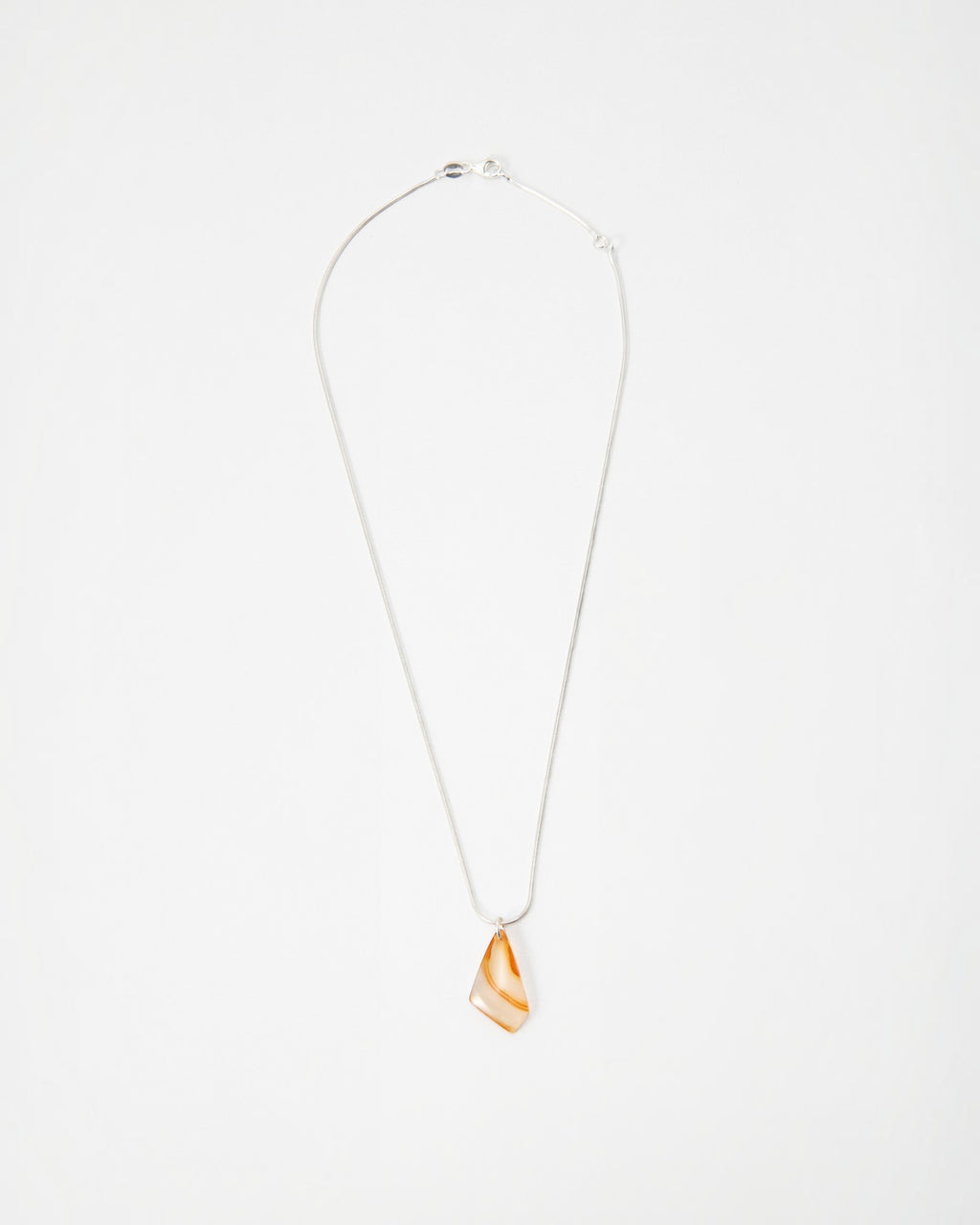 Elsita Jewelry Citrus II necklace featuring a translucent orange and white agate pendant on a delicate silver chain