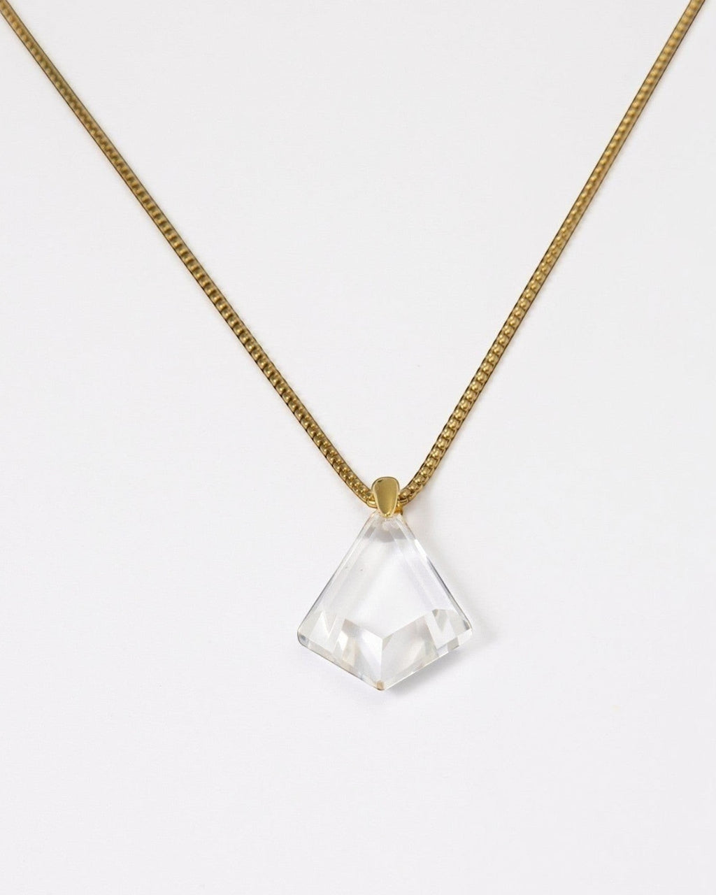 Elsita Jewelry Lustre III necklace featuring a clear quartz pendant on a gold-toned stainless steel chain.
