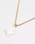 Elsita Jewelry Lustre III necklace featuring a faceted clear quartz pendant on a gold-tone stainless steel chain.