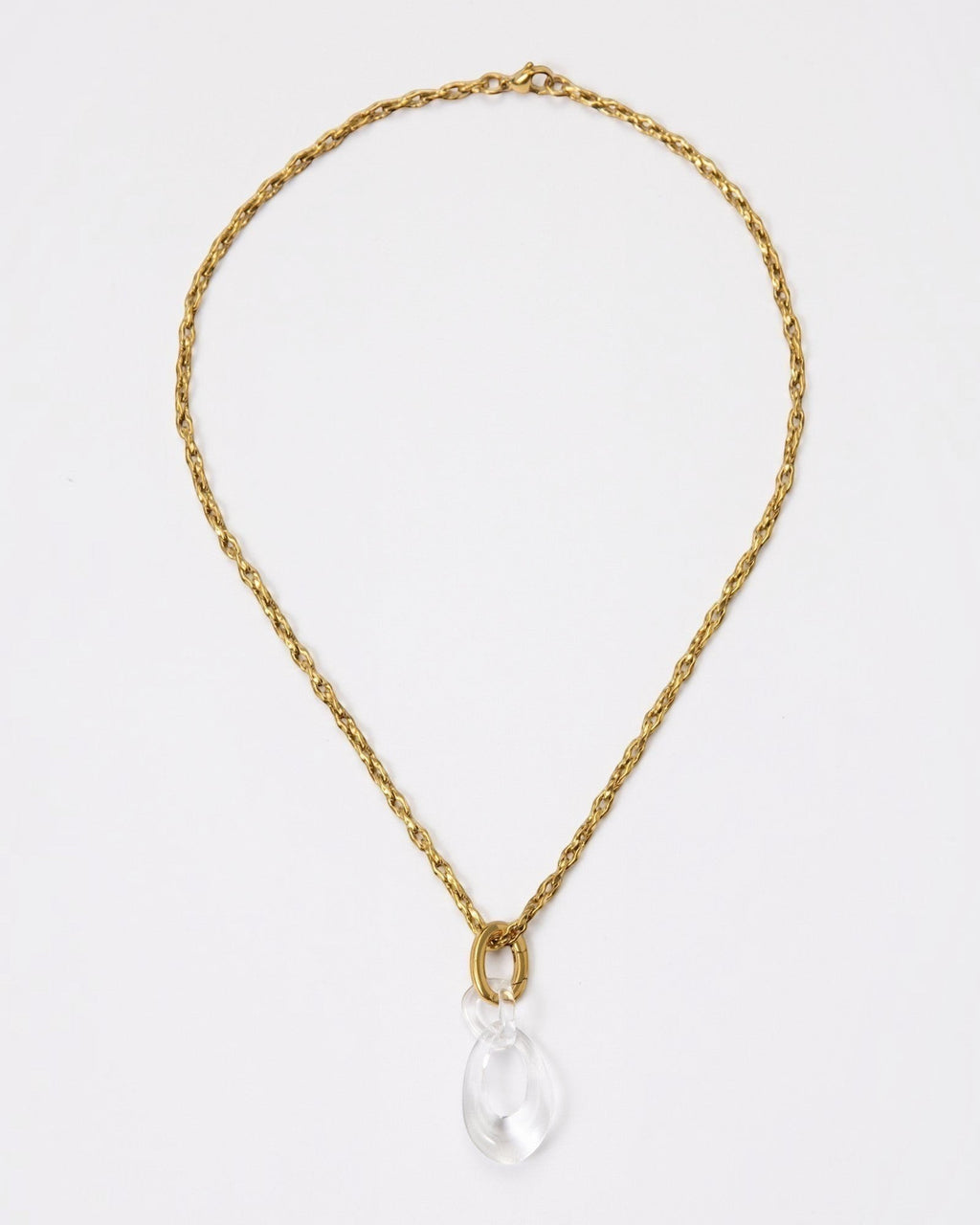 Elsita Jewelry Link Clear necklace featuring a hand-carved clear quartz interlocked chain pendant on a gold chain.