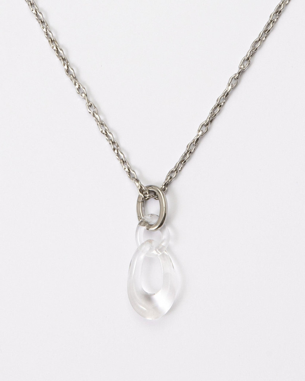 Elsita Jewelry Link Clear necklace featuring a hand-carved clear quartz interlocked chain pendant on a silver-tone chain.