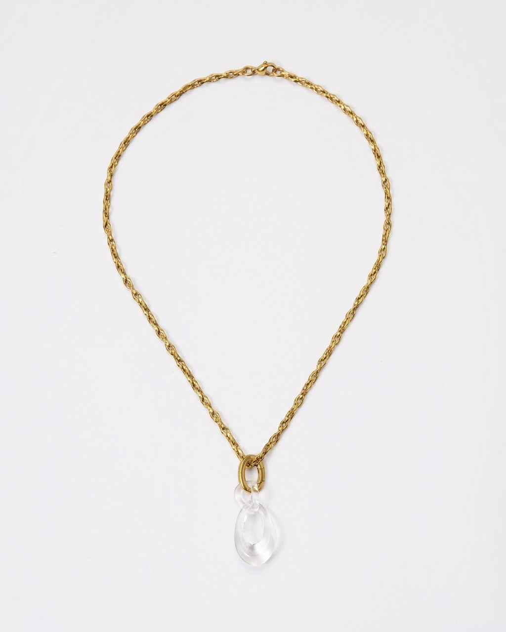 Elsita Jewelry Link Clear necklace featuring a hand-carved clear quartz interlocked chain pendant on a gold chain.