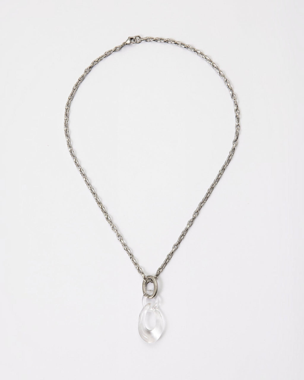 Elsita Jewelry Link Clear necklace featuring a hand-carved clear quartz interlocked chain pendant on a silver-tone chain.