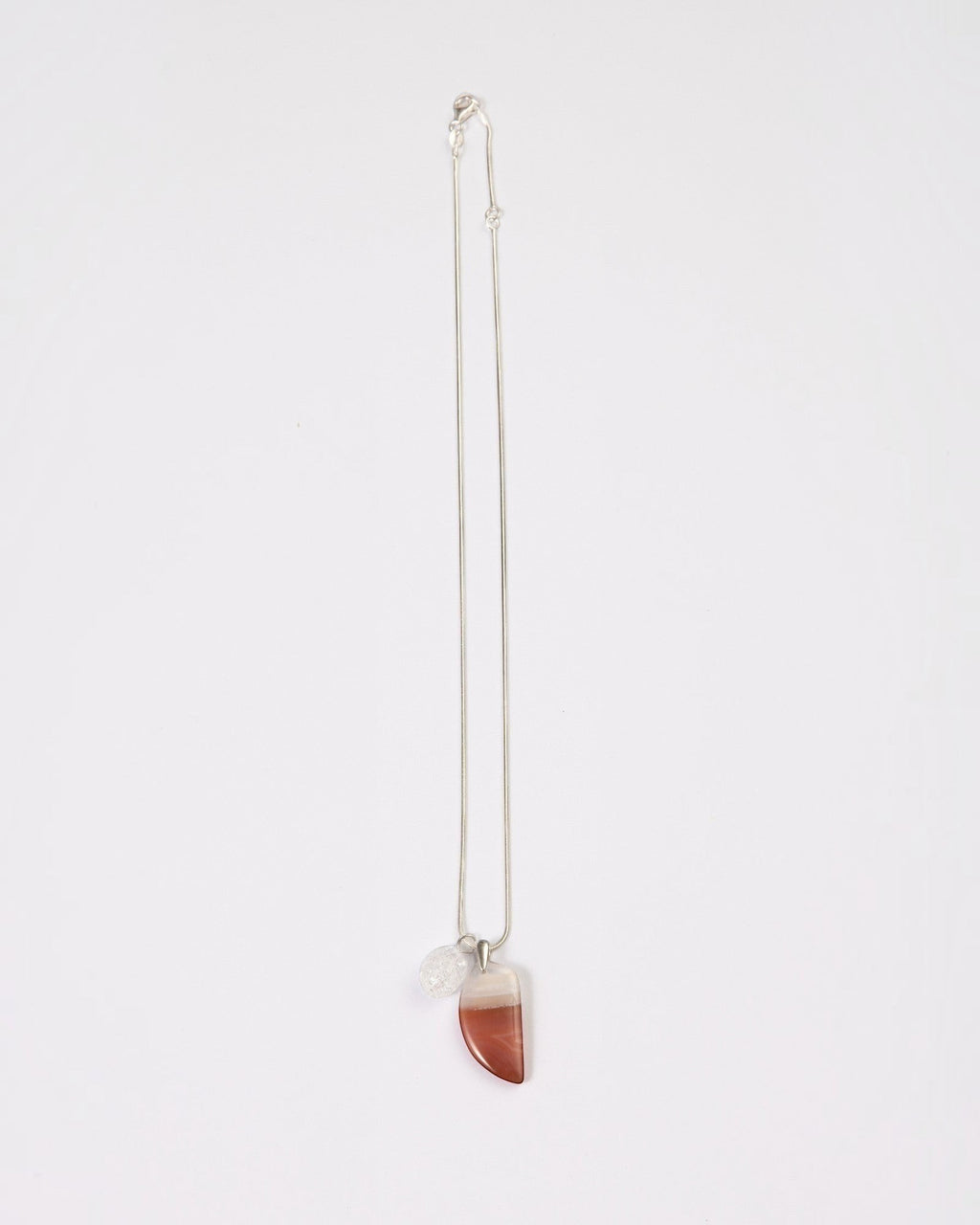 Elsita Jewelry Soda IV crescent red agate and clear quartz pendant necklace on a sterling silver snake chain