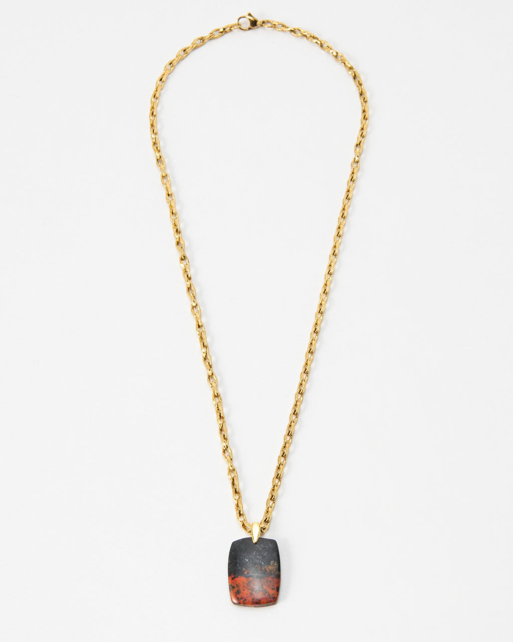 Elsita Jewelry Dune Day necklace featuring a rectangular stone pendant with black and red tones on a gold chain