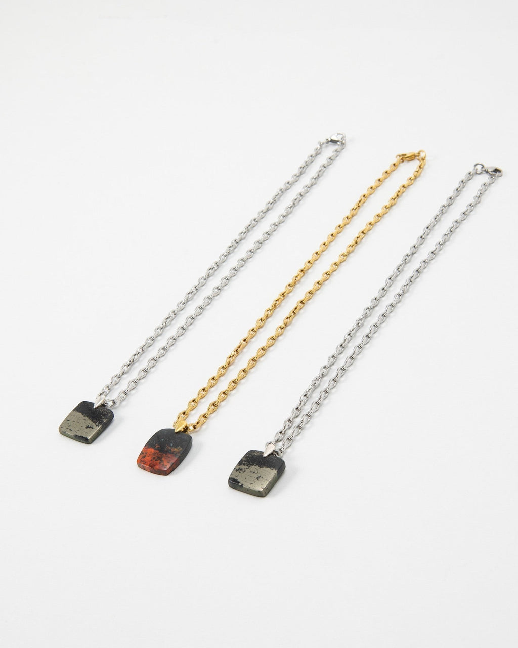 Elsita Jewelry Dune Night necklaces featuring rectangular stone pendants on silver and gold link chains