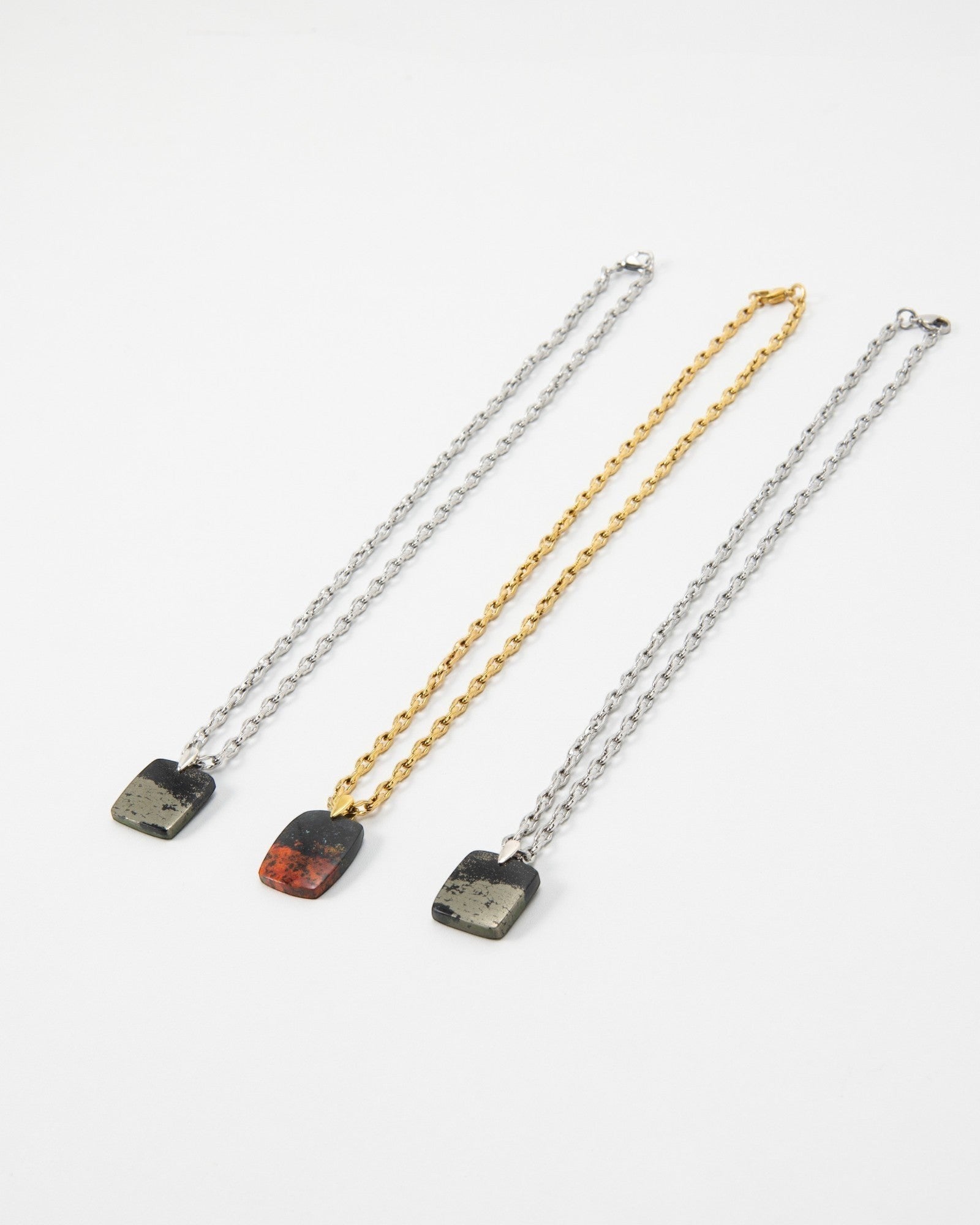 Elsita Jewelry Dune Night necklaces featuring rectangular stone pendants on silver and gold link chains