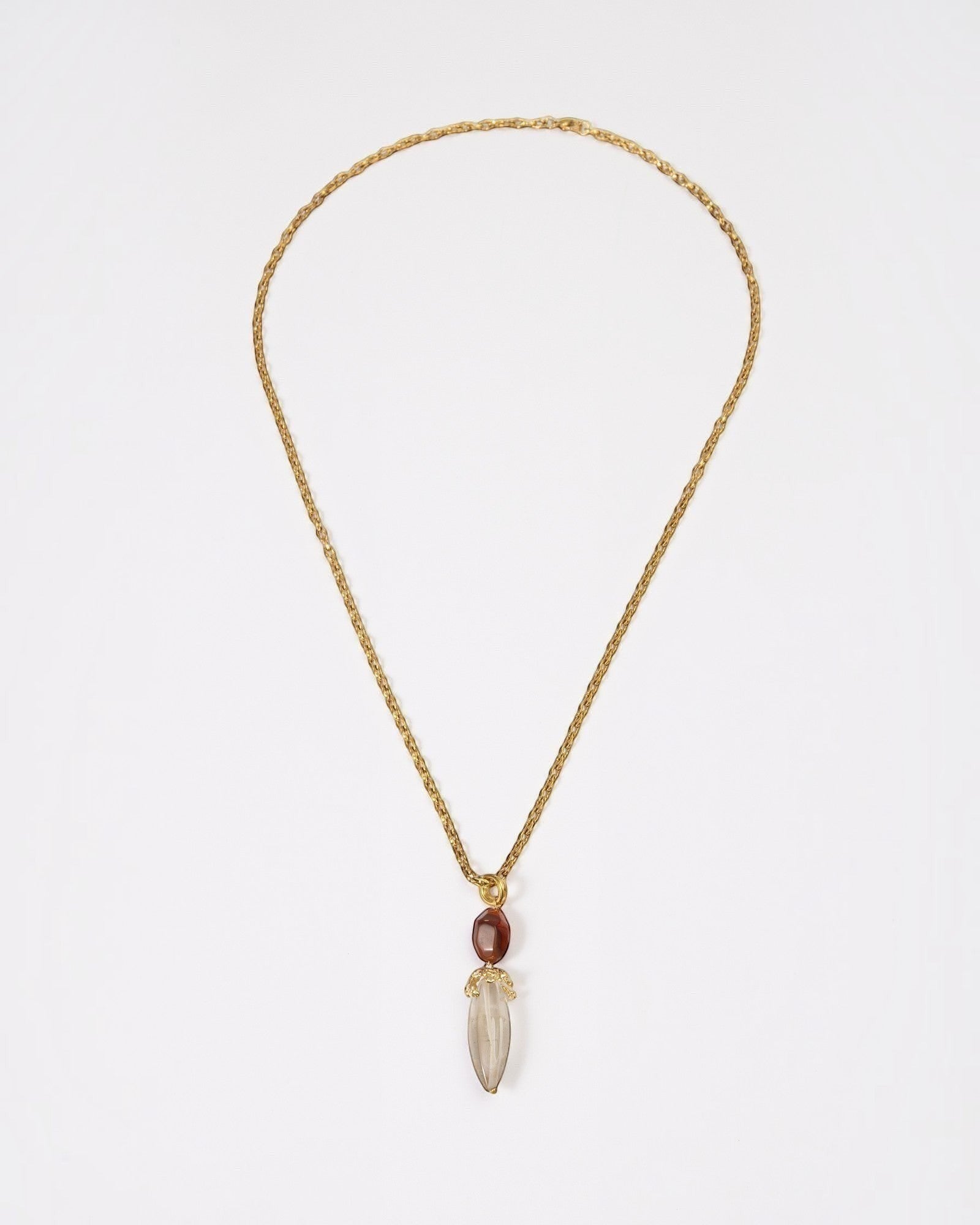 Elsita Jewelry Flame necklace featuring a raw clear quartz pendant and red agate on a textured gold chain.