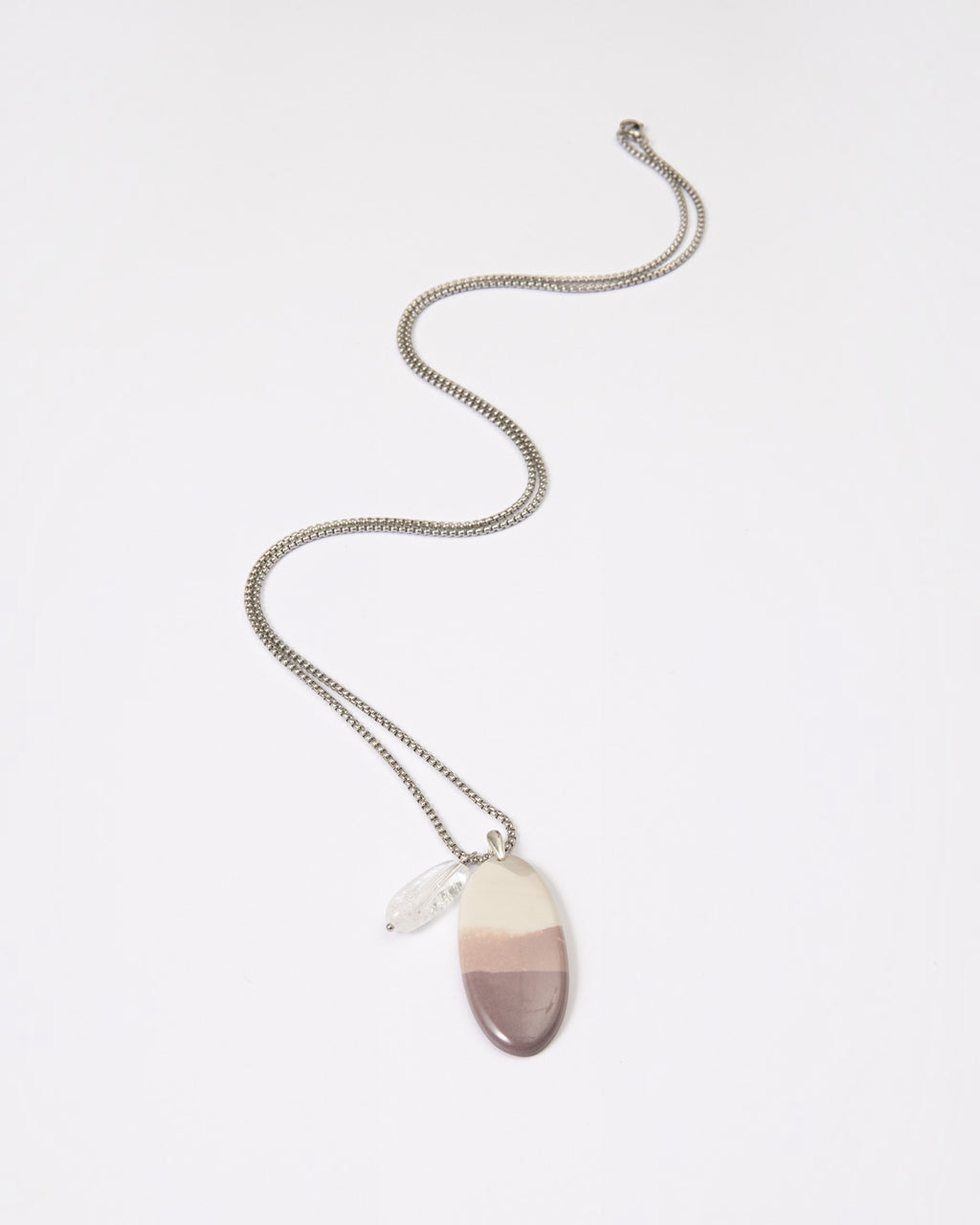 Elsita Jewelry Mauve I necklace featuring a smooth Hyacinth Jasper pendant with lavender tones and a clear quartz charm.