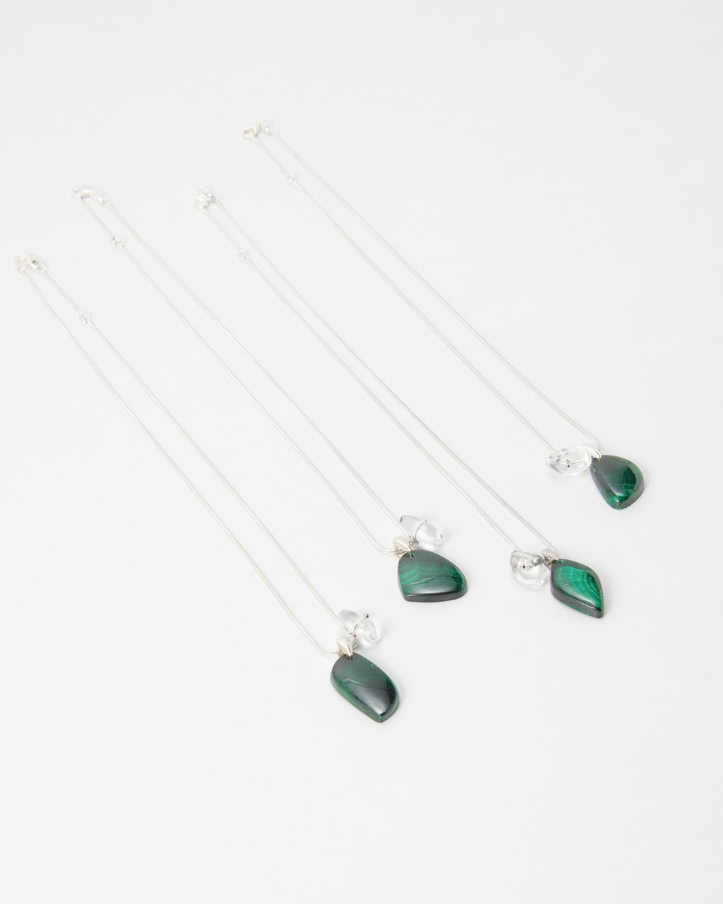 Elsita Jewelry Midnight necklaces featuring polished green malachite teardrop pendants on delicate silver chains.