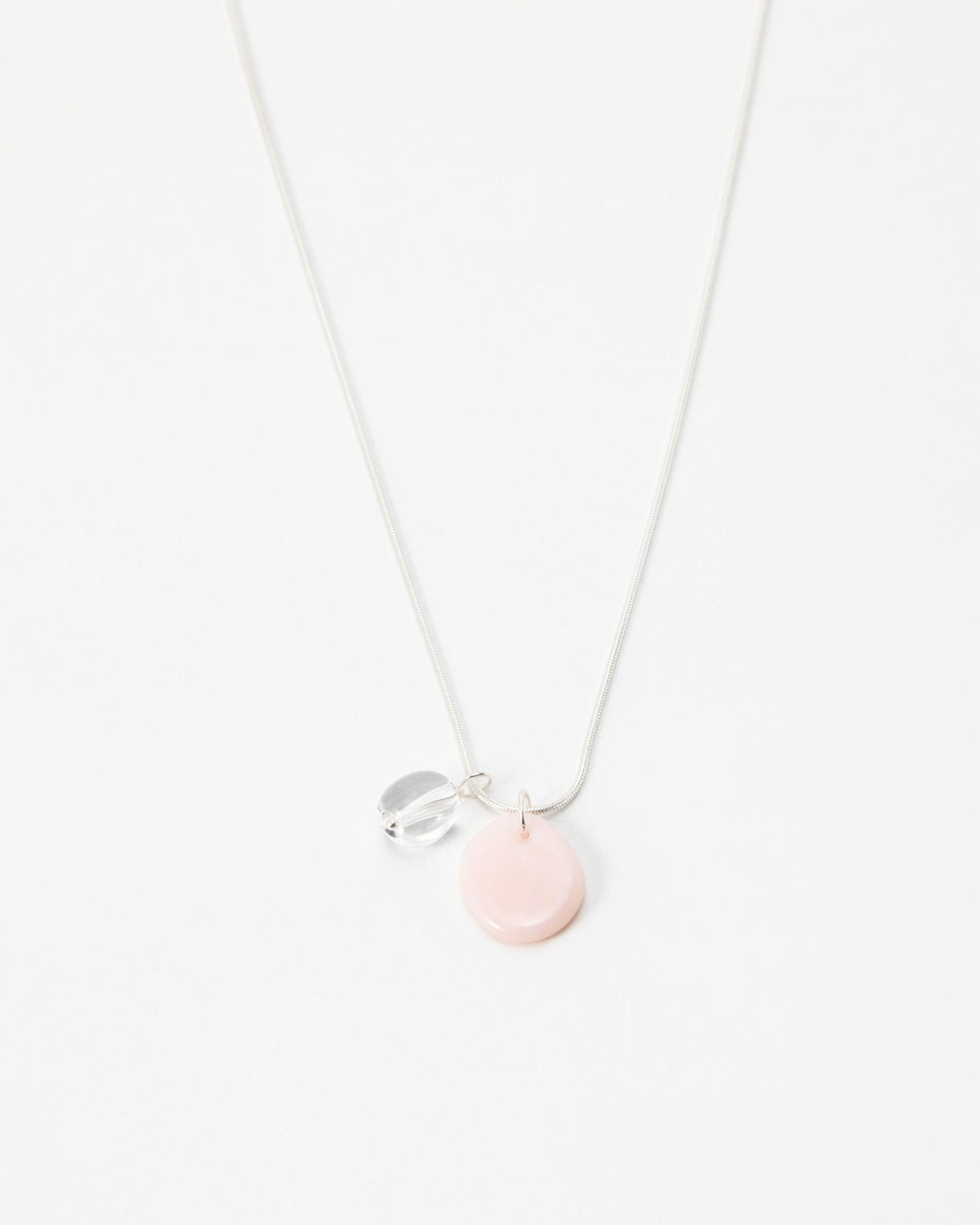 Elsita Jewelry Petal Clear necklace featuring a delicate silver chain with a soft pink disc and clear crystal charm.