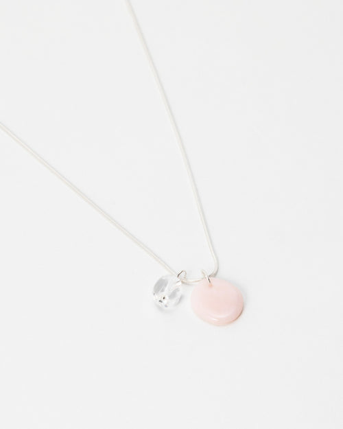 Elsita Jewelry Petal Clear necklace featuring a delicate silver chain with a pink disc and clear crystal charm