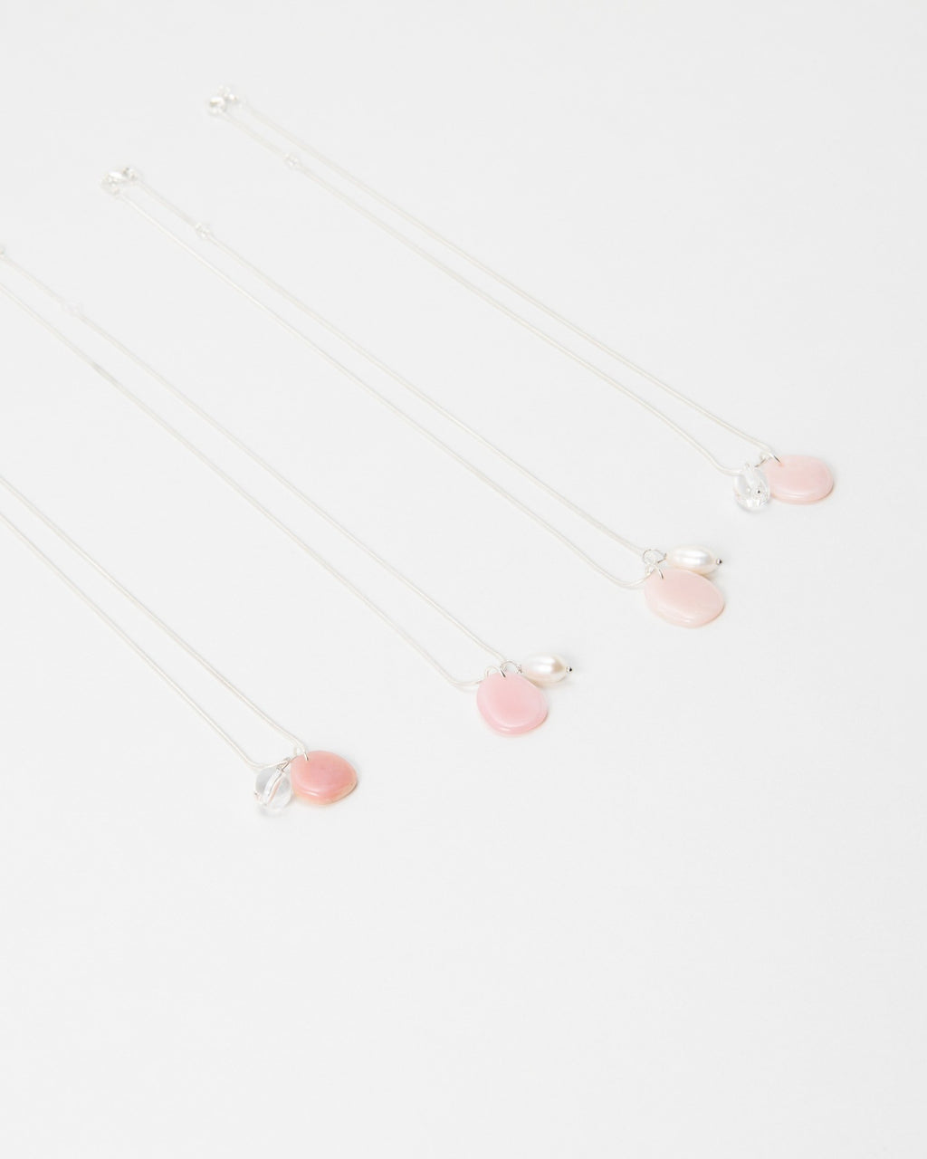 Elsita Jewelry Petal Clear necklaces featuring delicate pink petal charms and clear accents on silver chains