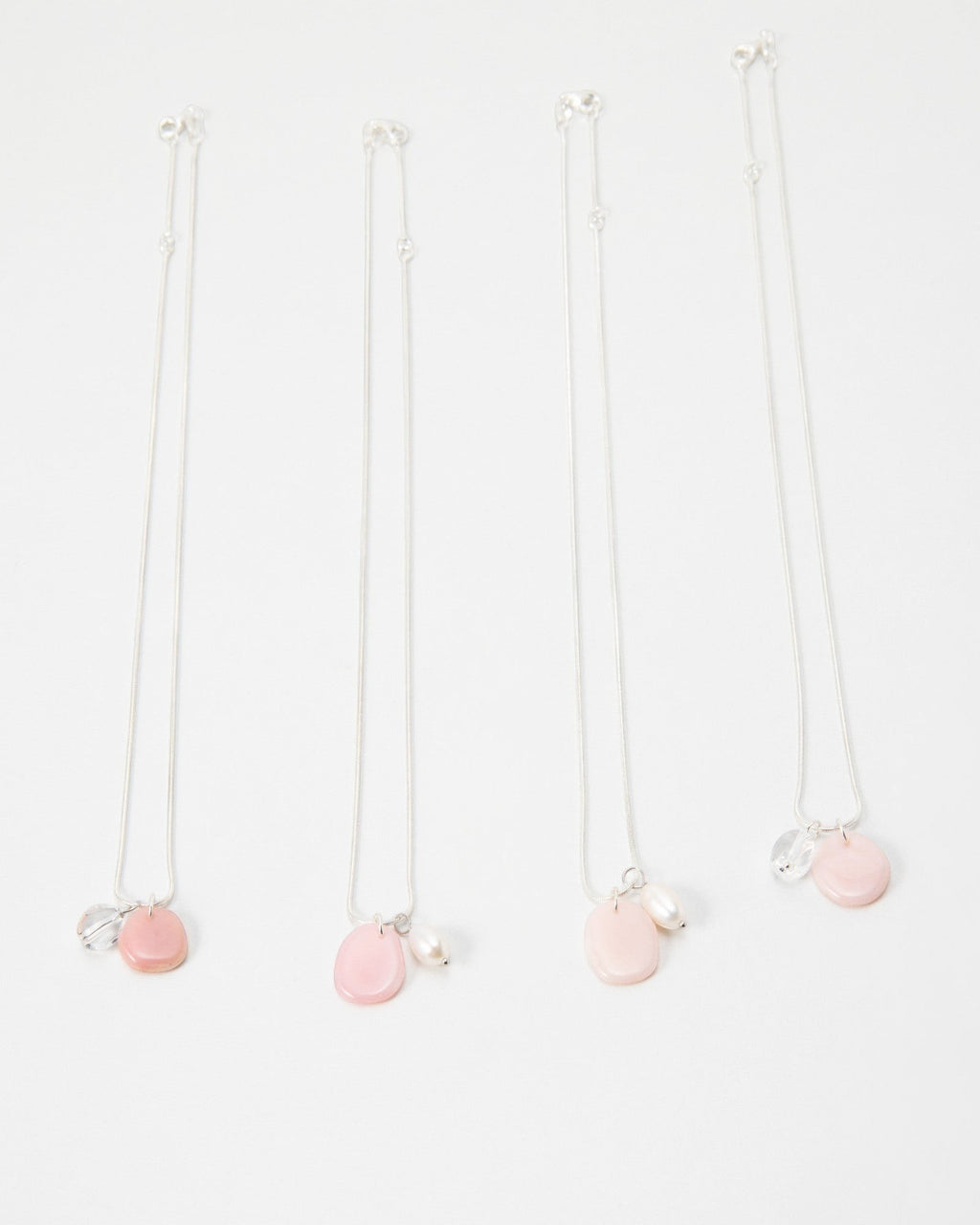 Elsita Jewelry Petal Pearl necklaces featuring delicate pink stone charms and white pearls on silver chains
