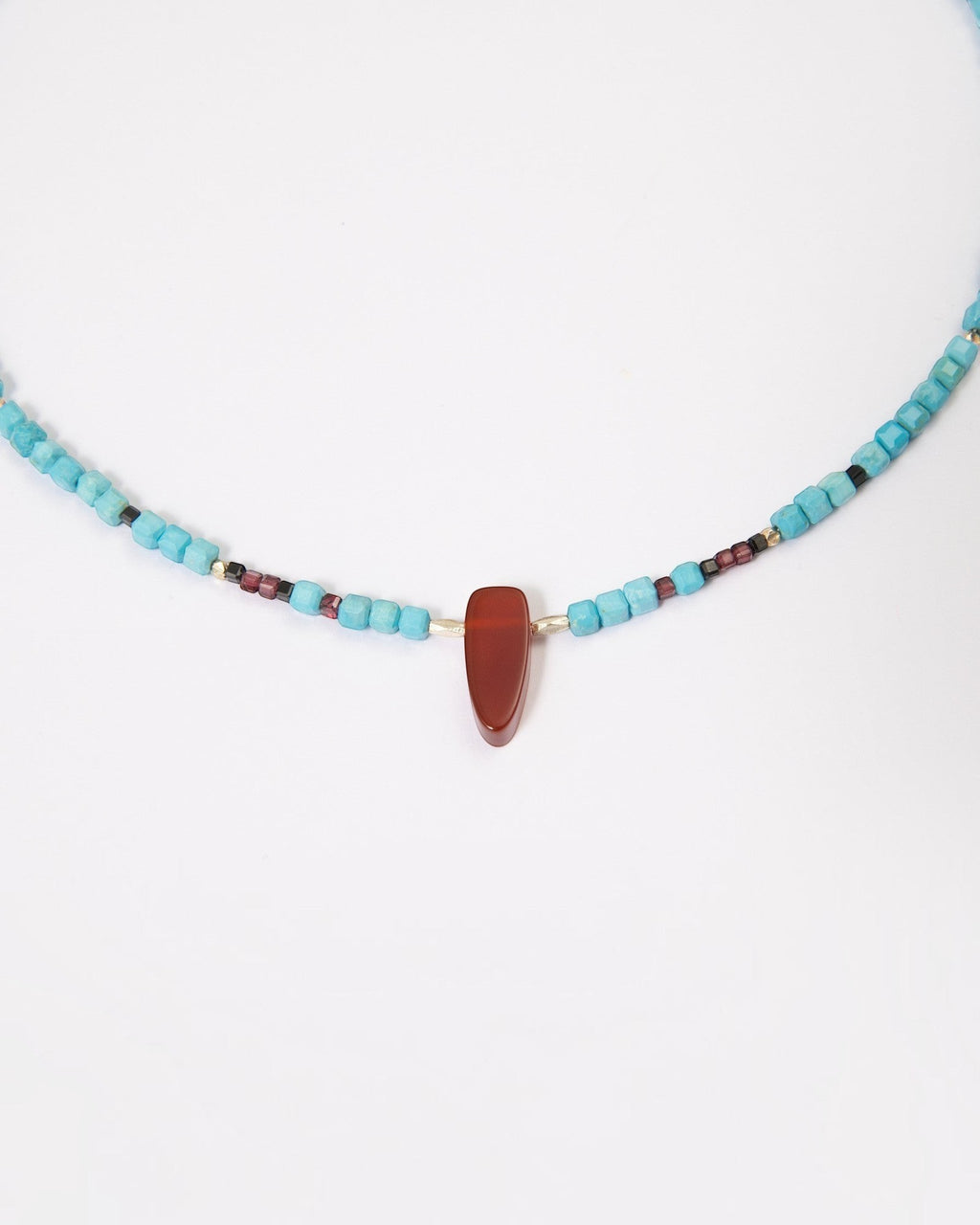 Elsita Jewelry Pixel necklace featuring turquoise cubes, a red agate pendant, garnet, black spinel, and silver beads.