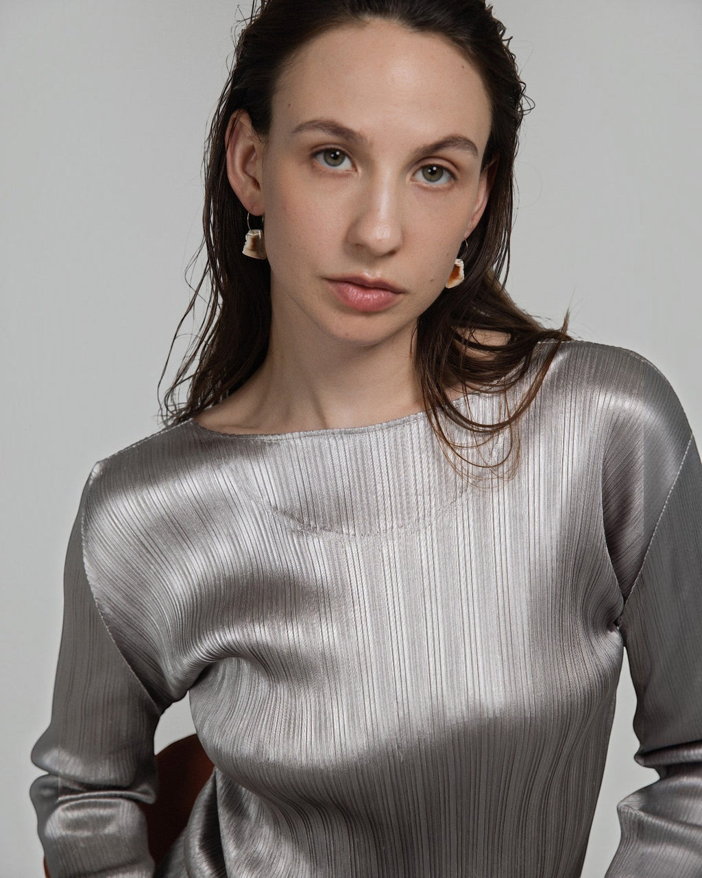Model wearing Elsita Jewelry Wild 2 raw Indonesian agate earrings on 14K gold-filled hoops against a neutral background