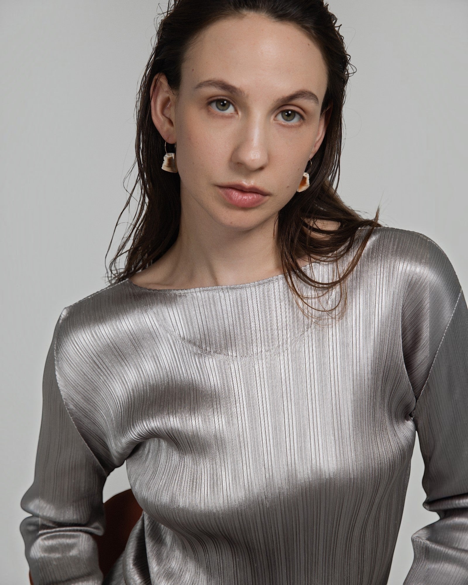 Model wearing Elsita Jewelry Wild 2 raw Indonesian agate earrings on 14K gold-filled hoops against a neutral background