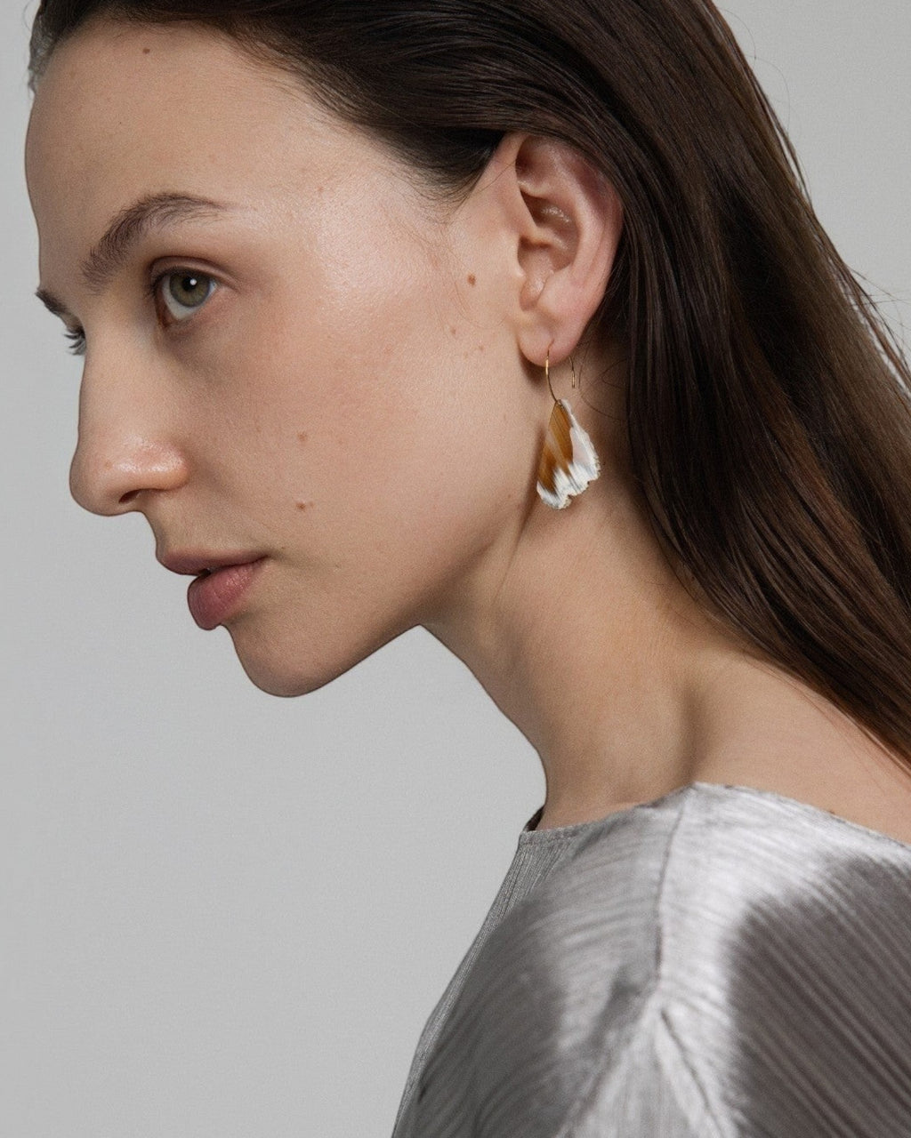 Elsita Jewelry Wild 18 raw Indonesian agate slice earrings on 14K gold-filled hoops worn by a model in profile