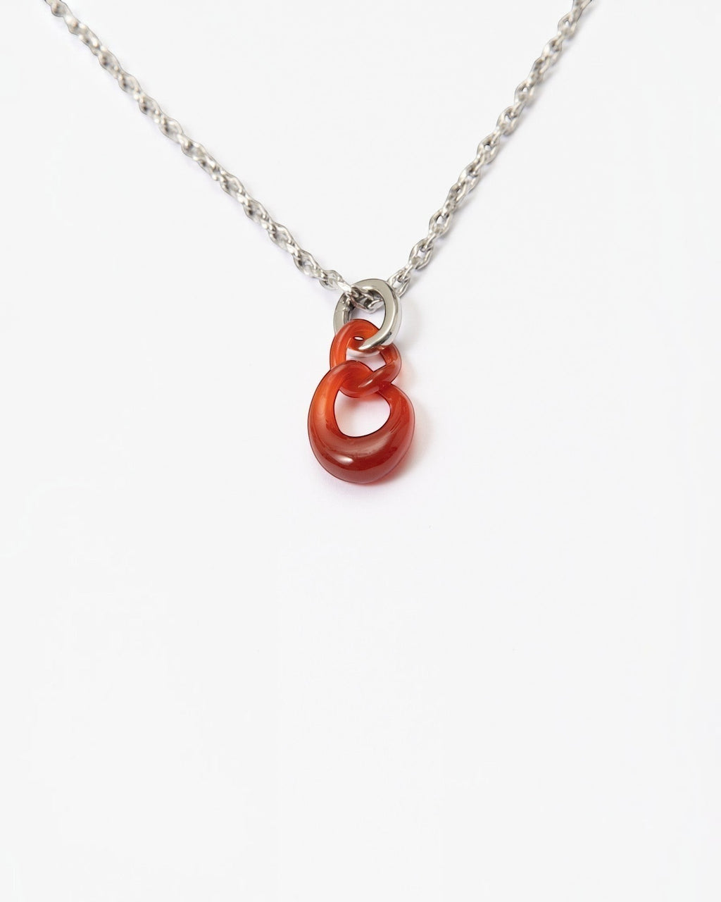 Elsita Jewelry Link Red necklace featuring two hand-carved interlocked red agate stone chain links on a silver chain.