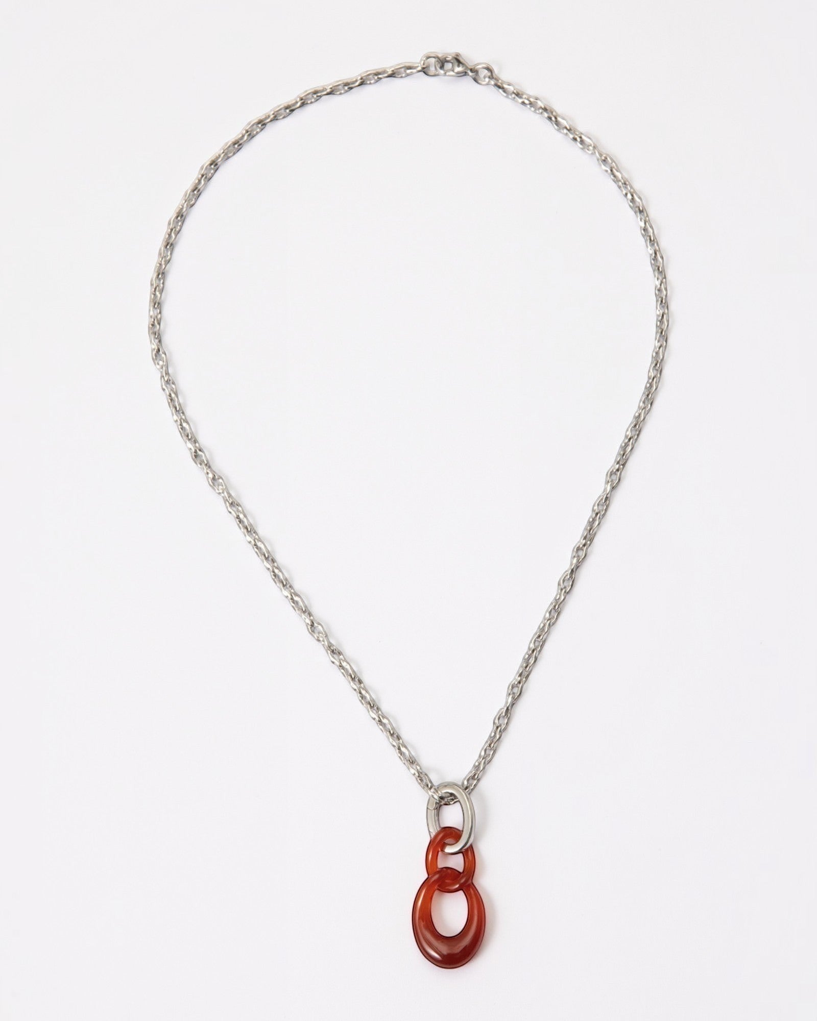 Elsita Jewelry Link Red necklace featuring a hand-carved red agate interlocked chain pendant on a silver-tone chain.