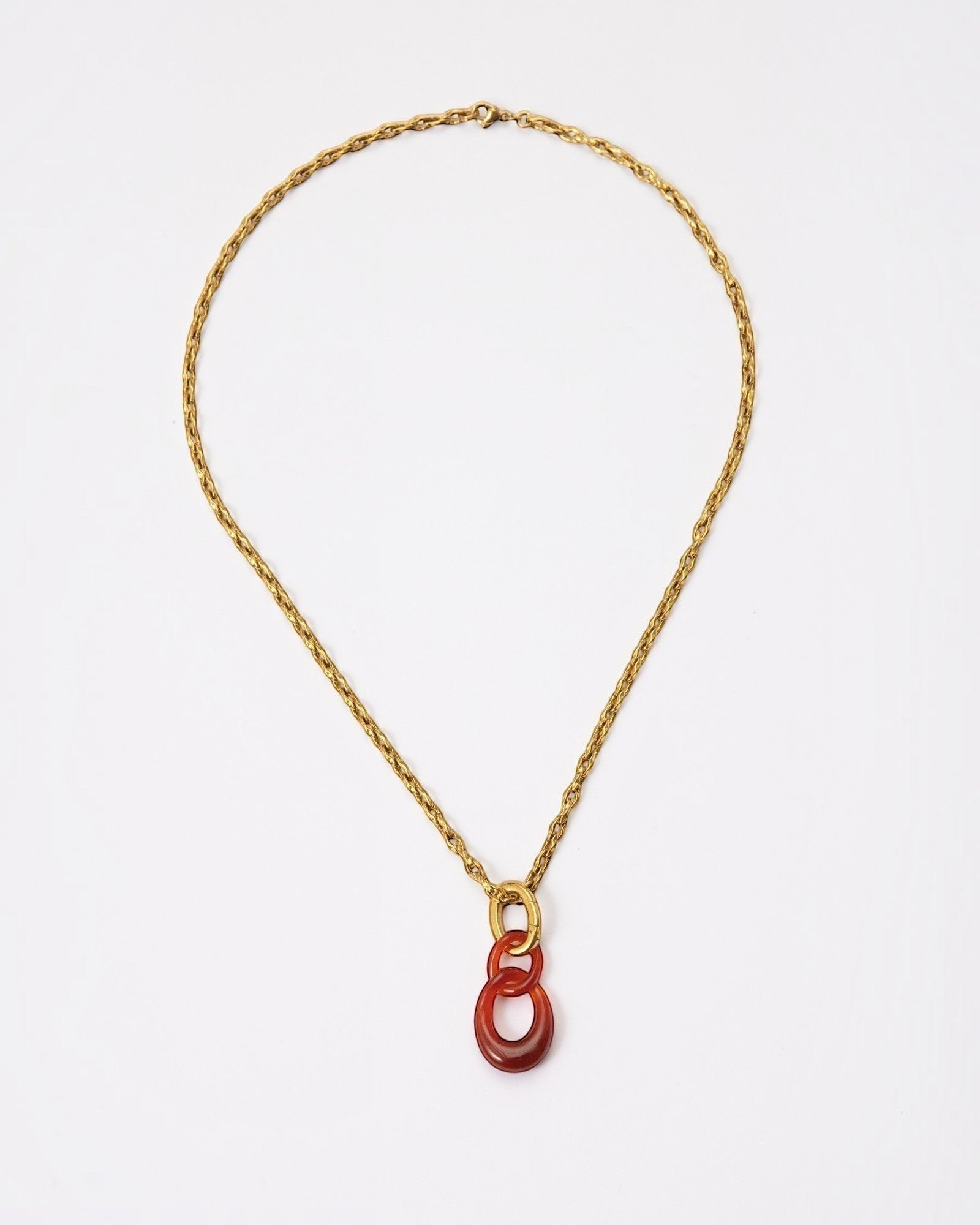 Elsita Jewelry Link Red necklace featuring hand-carved red agate interlocked chain pendant on a gold-tone metal chain.