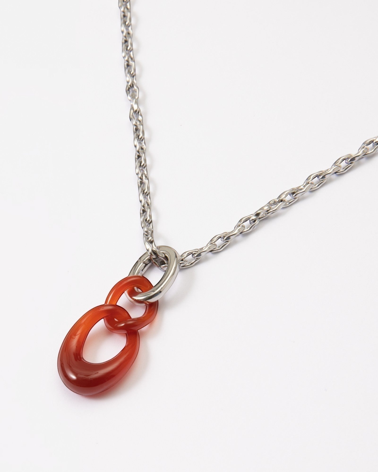 Elsita Jewelry Link Red necklace featuring a hand-carved red agate interlocked chain pendant on a silver-tone chain.