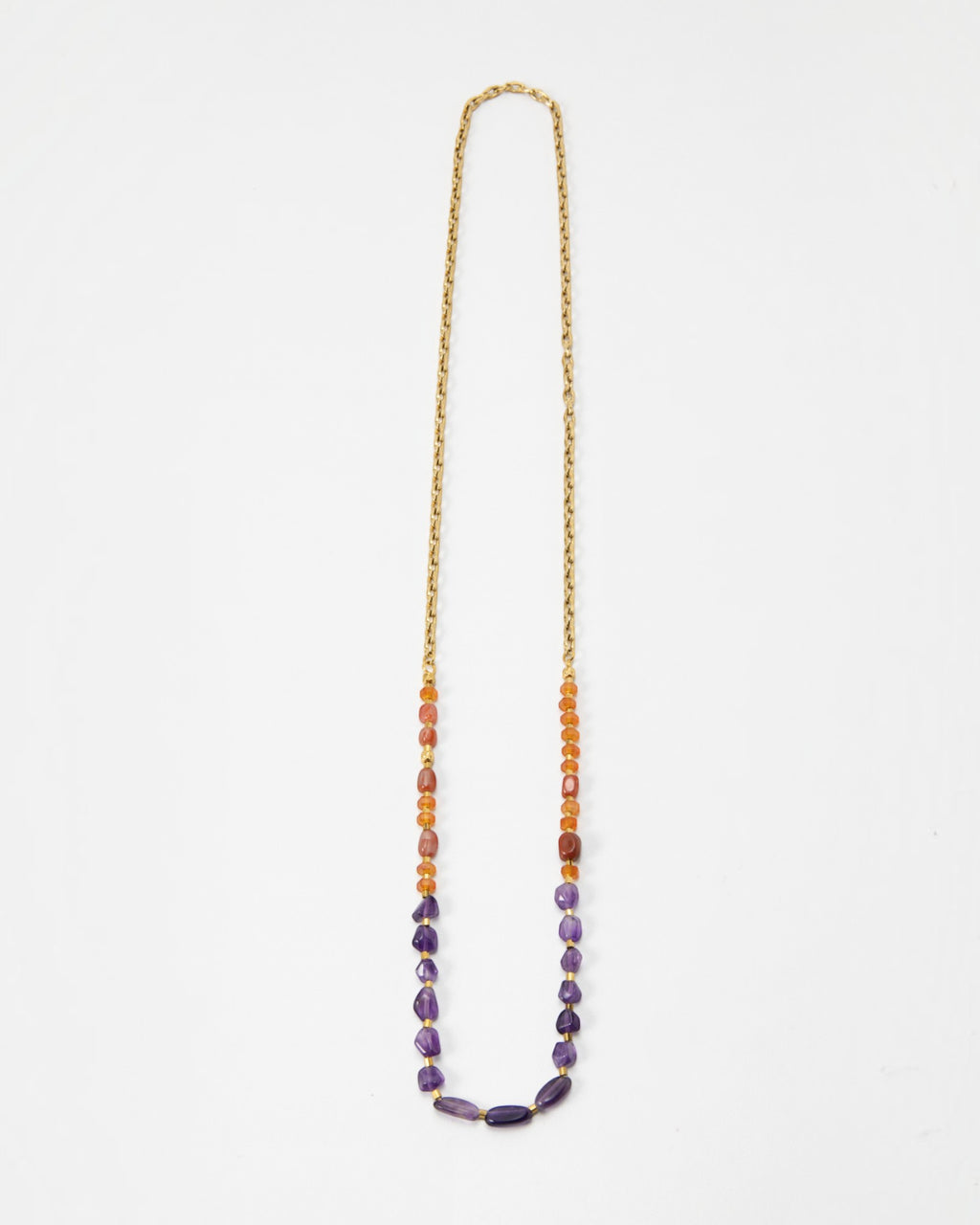 Elsita Jewelry Rhythm long necklace featuring red agate, carnelian, and amethyst beads on a gold stainless steel chain.