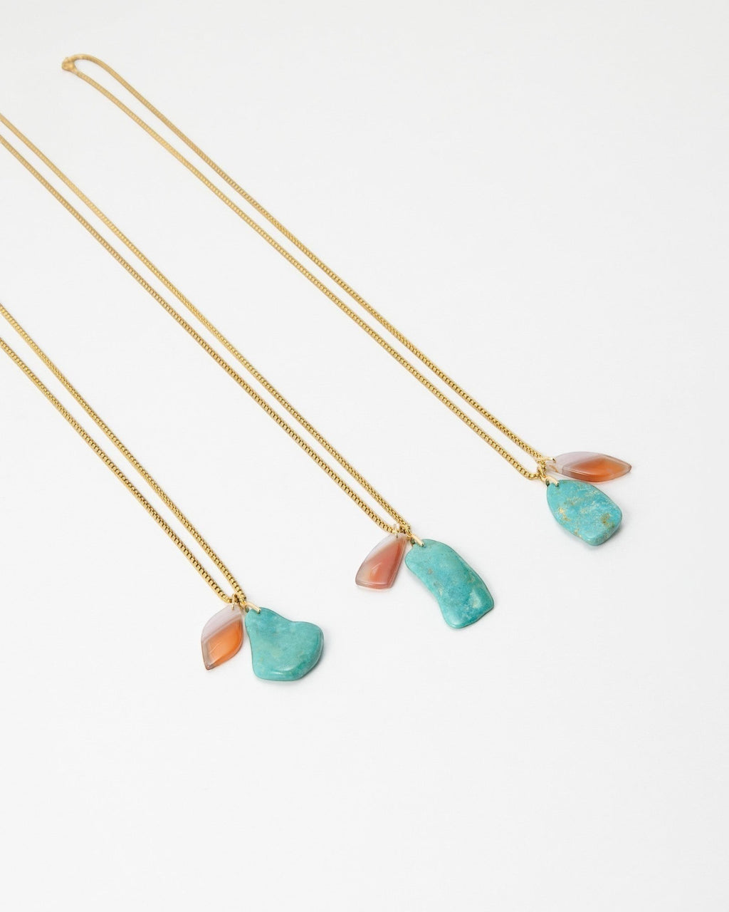 Elsita Jewelry Rusty II gold chain necklaces featuring raw turquoise and orange stone pendants