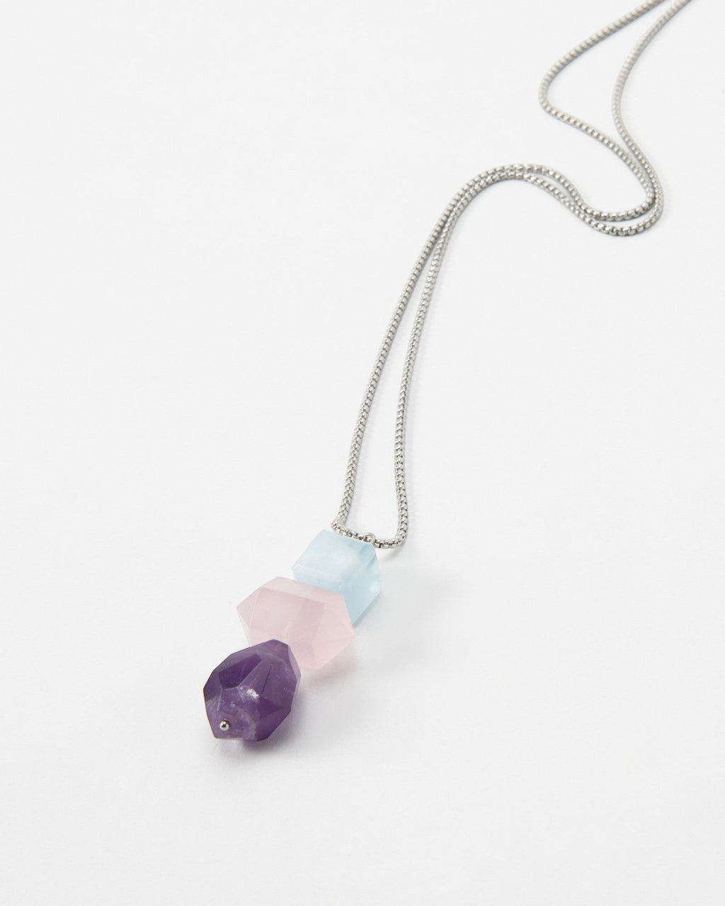 Elsita Jewelry Shape necklace featuring three faceted geometric gemstone beads in purple, pink, and light blue.