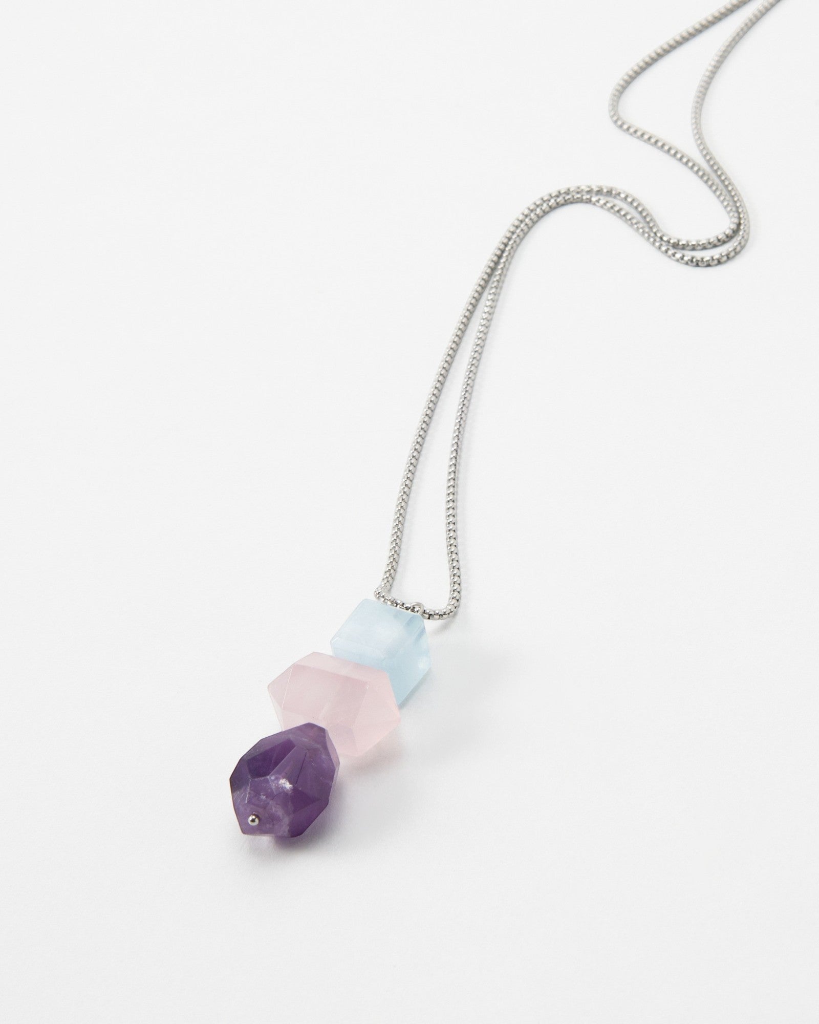Elsita Jewelry Shape necklace featuring three faceted geometric gemstone beads in purple, pink, and light blue.