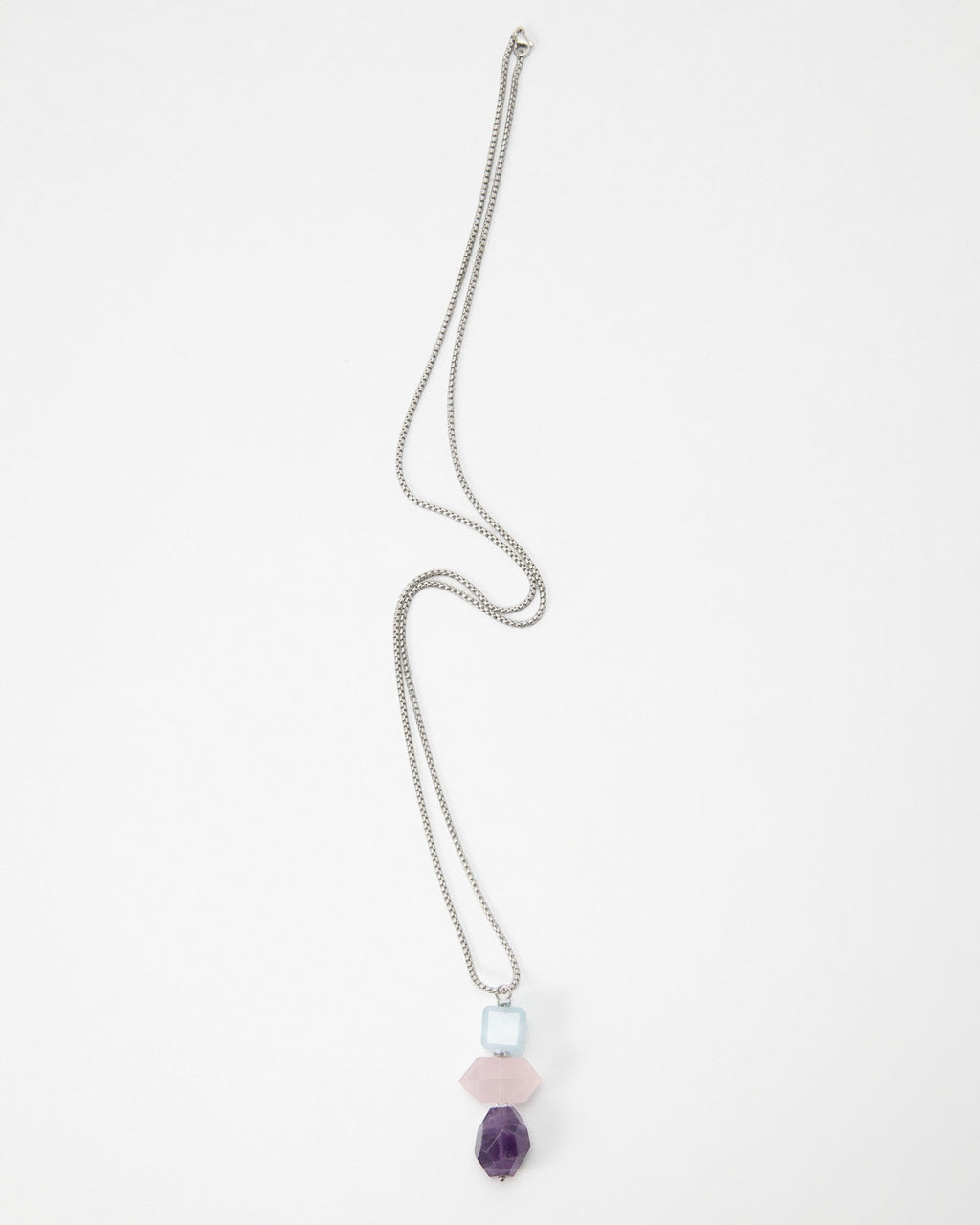 Elsita Jewelry Shape necklace featuring a silver chain with stacked light blue, pink, and purple geometric beads.