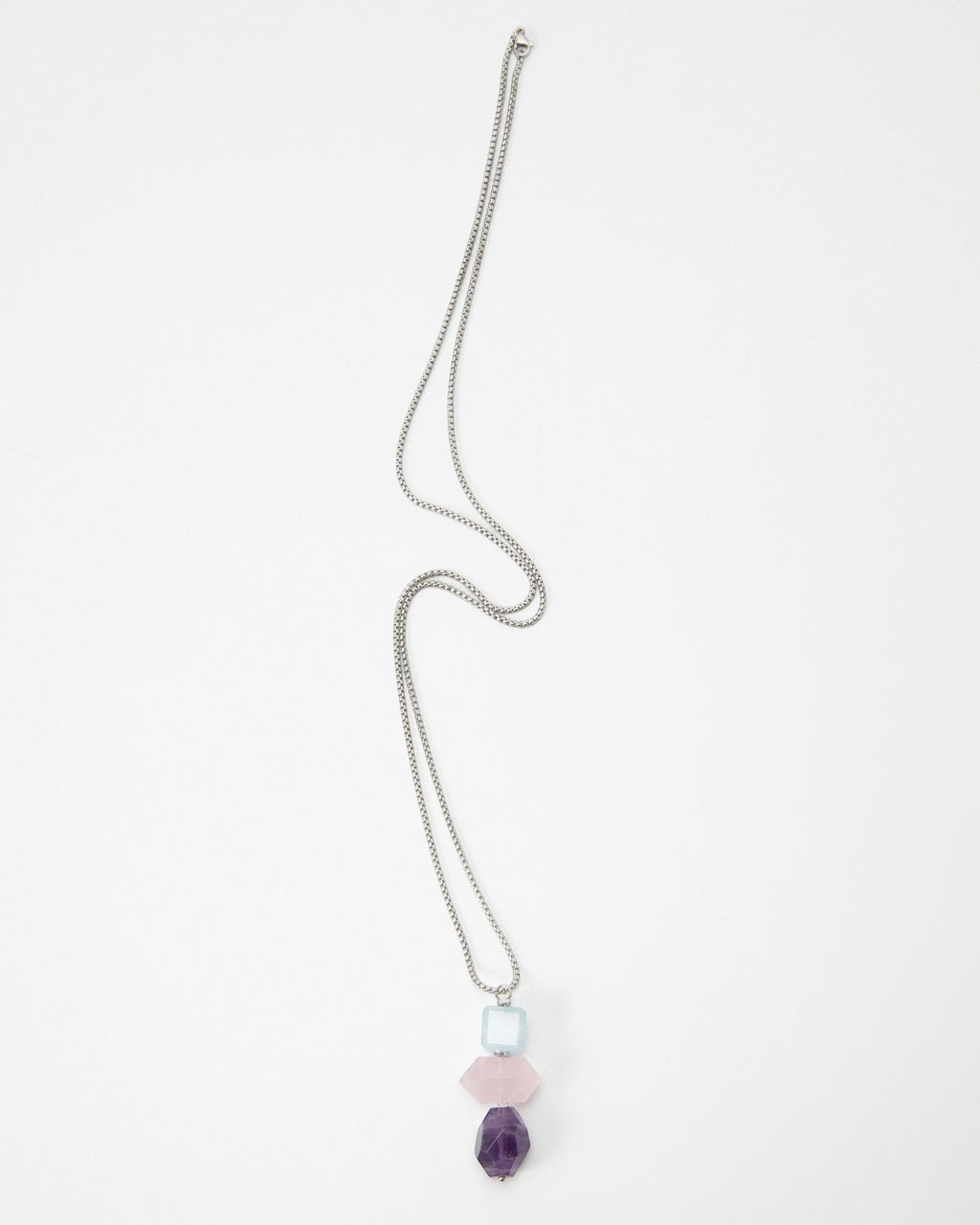 Elsita Jewelry Shape necklace featuring a silver chain with stacked light blue, pink, and purple geometric beads.