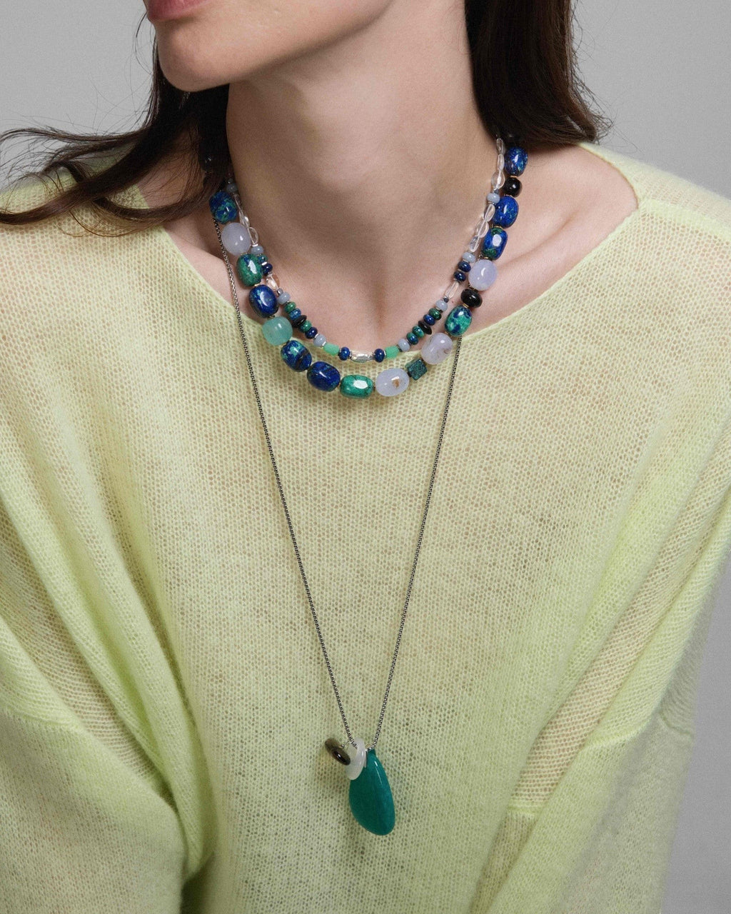 Model wearing Elsita Jewelry Stein am Rhein necklace with Amazonite, Smoky Quartz, and White Agate on a silver chain.