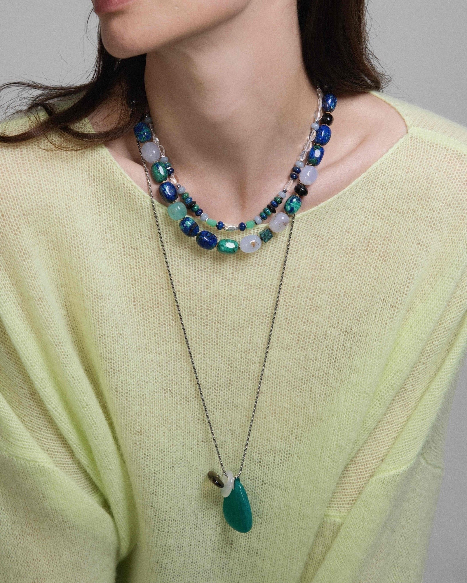 Model wearing Elsita Jewelry Stein am Rhein necklace with Amazonite, Smoky Quartz, and White Agate on a silver chain.