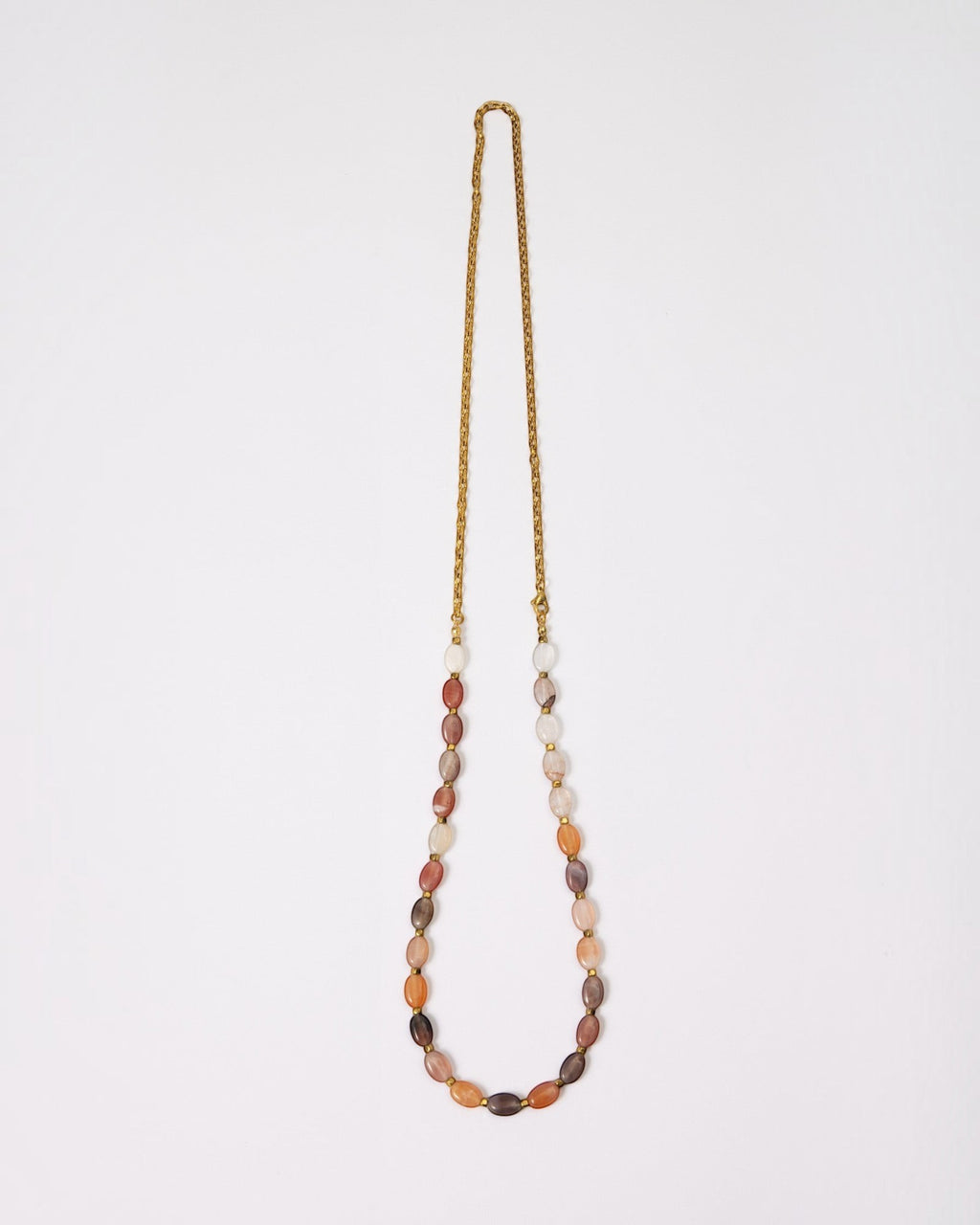 Elsita Jewelry Terrain long necklace featuring oval mixed agate stones in earth tones with a gold-tone chain.