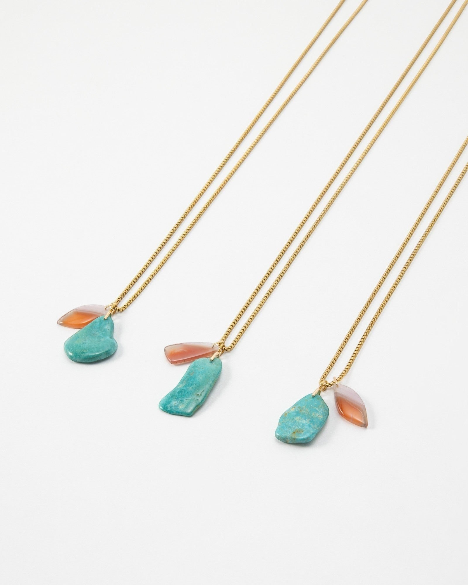Elsita Jewelry Rusty II necklaces featuring turquoise and carnelian stones on delicate gold chains.
