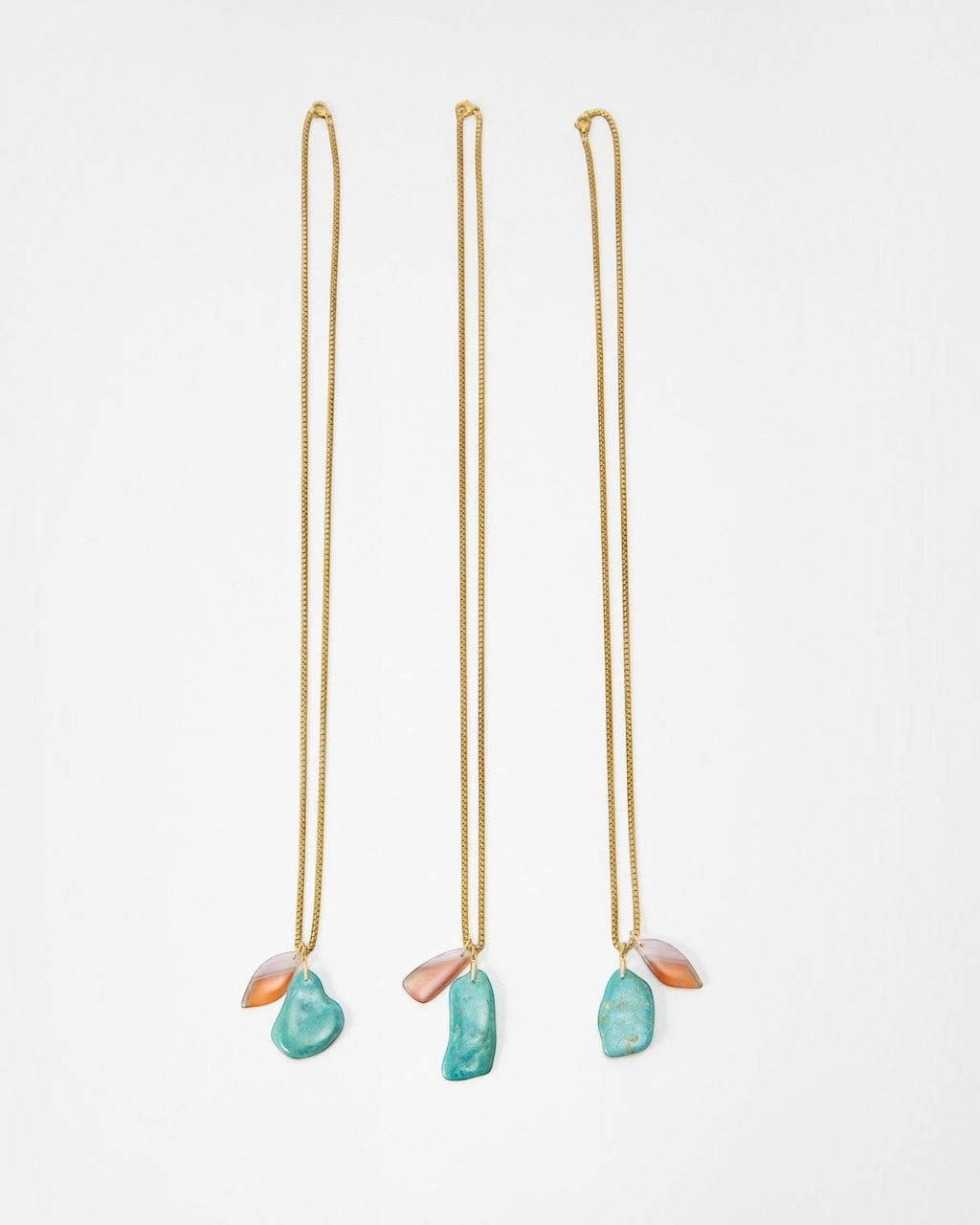 Elsita Jewelry Rusty II gold chain necklaces featuring organic turquoise and translucent peach stone pendants