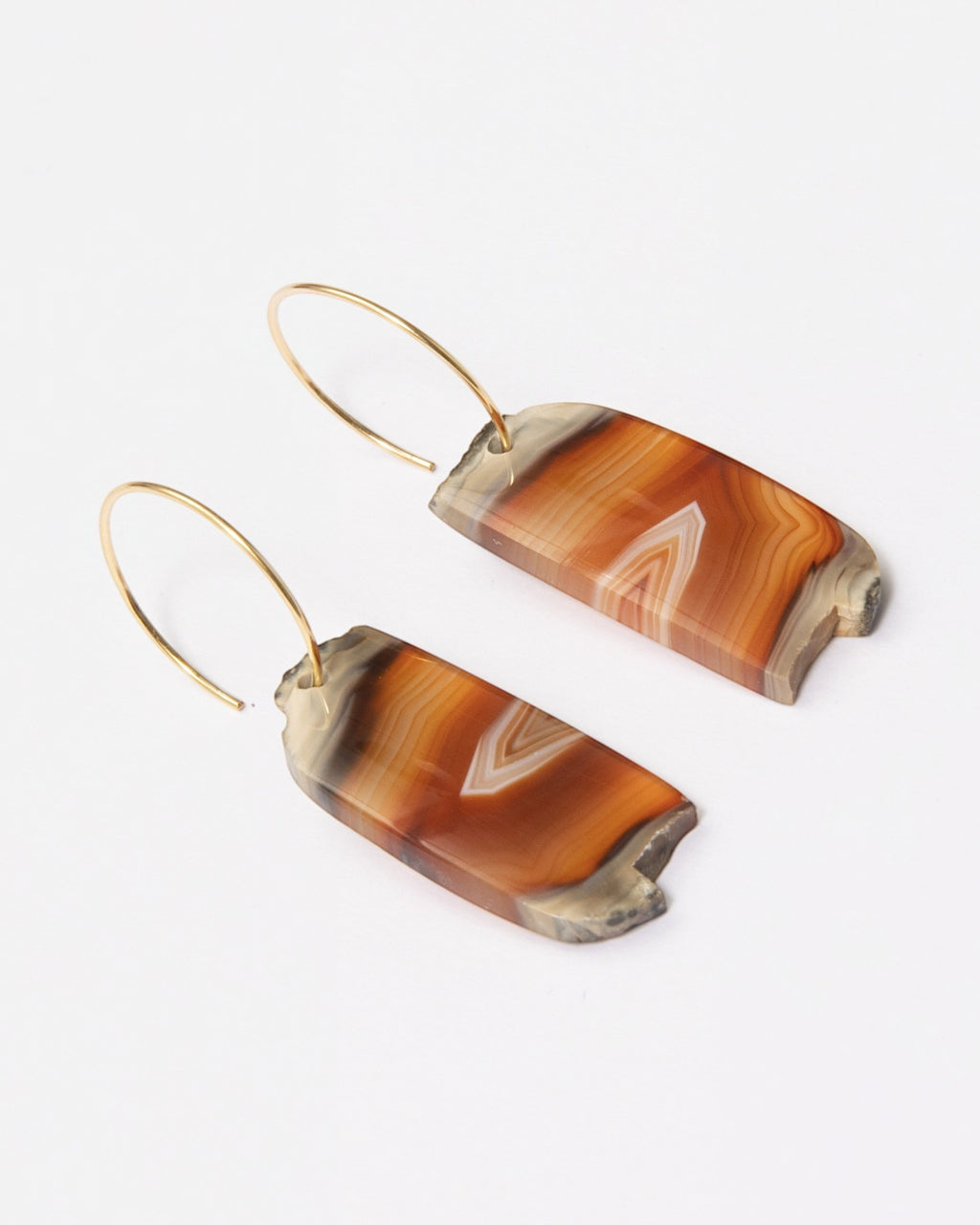 Elsita Jewelry Wild 14 agate earrings featuring raw, freeform orange and brown stone slices on 14K gold-filled hoops.